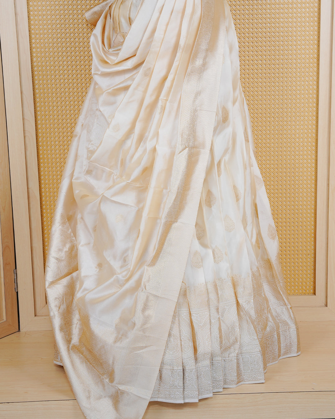 Cream coloured semi silk semi stitched dhavani set featuring gold zari Motifs on the body with a matching gold zari bordered skirt & blouse piece and dupatta.
