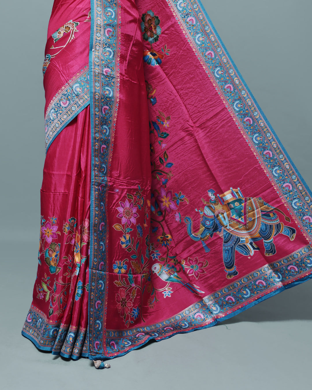 Rani Pink Colour Pashmina Saree featuring Plain body, complemented by Contrast Teal colour with Floral pattern & gold zari on border and Pallu, comes with matching blouse piece.