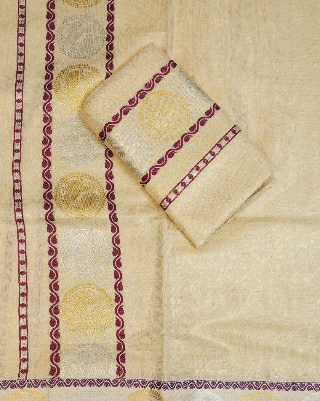 Golden colour Tissue silk set mundu features a plain body accented by a Grape with Gold & Silver Chakra Motifs on border.