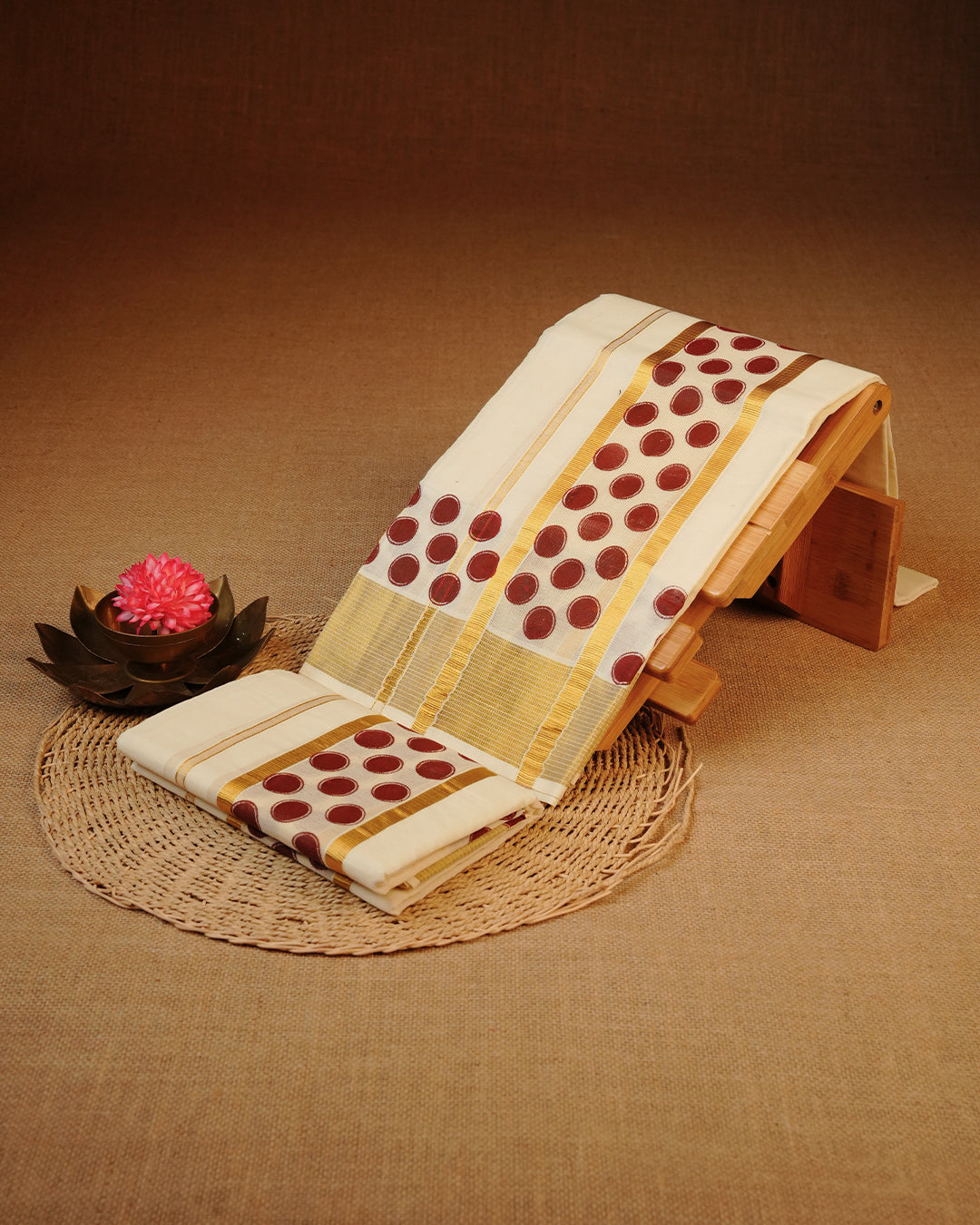 Cream colour cotton set mundu Features Plain body, Enhanced with Kasav kara with Brown colour circle motifs.