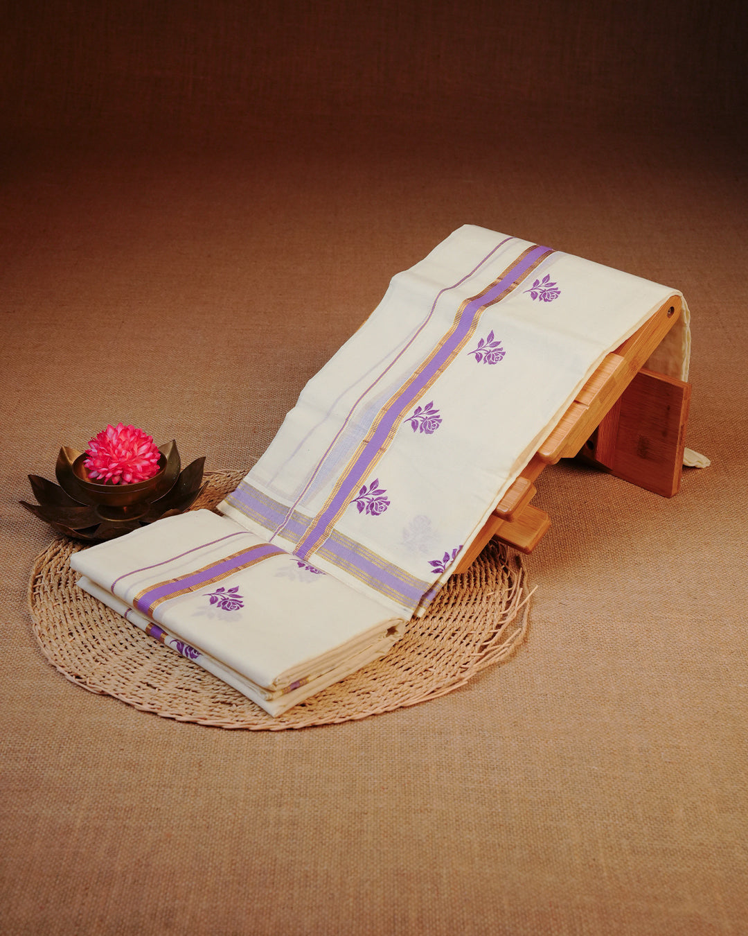 Cream colour cotton set mundu Featuring Elegant plain body, complemented by gold zari with Purple colour rose print kara.