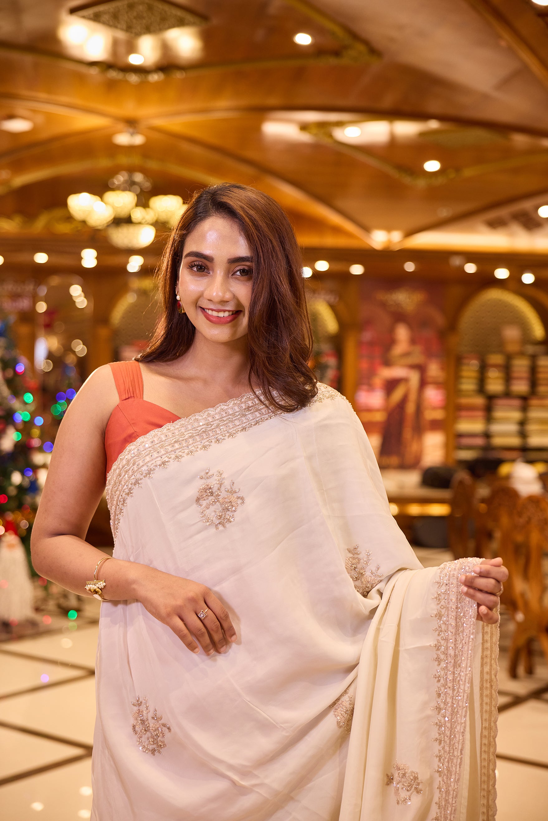 Cream colour pure organza saree with elegant hand embroidery featuring beads, sequins, pearls and thread detailing all over the body, finished with a beautifully crafted scallop border, paired with a matching worked blouse.
