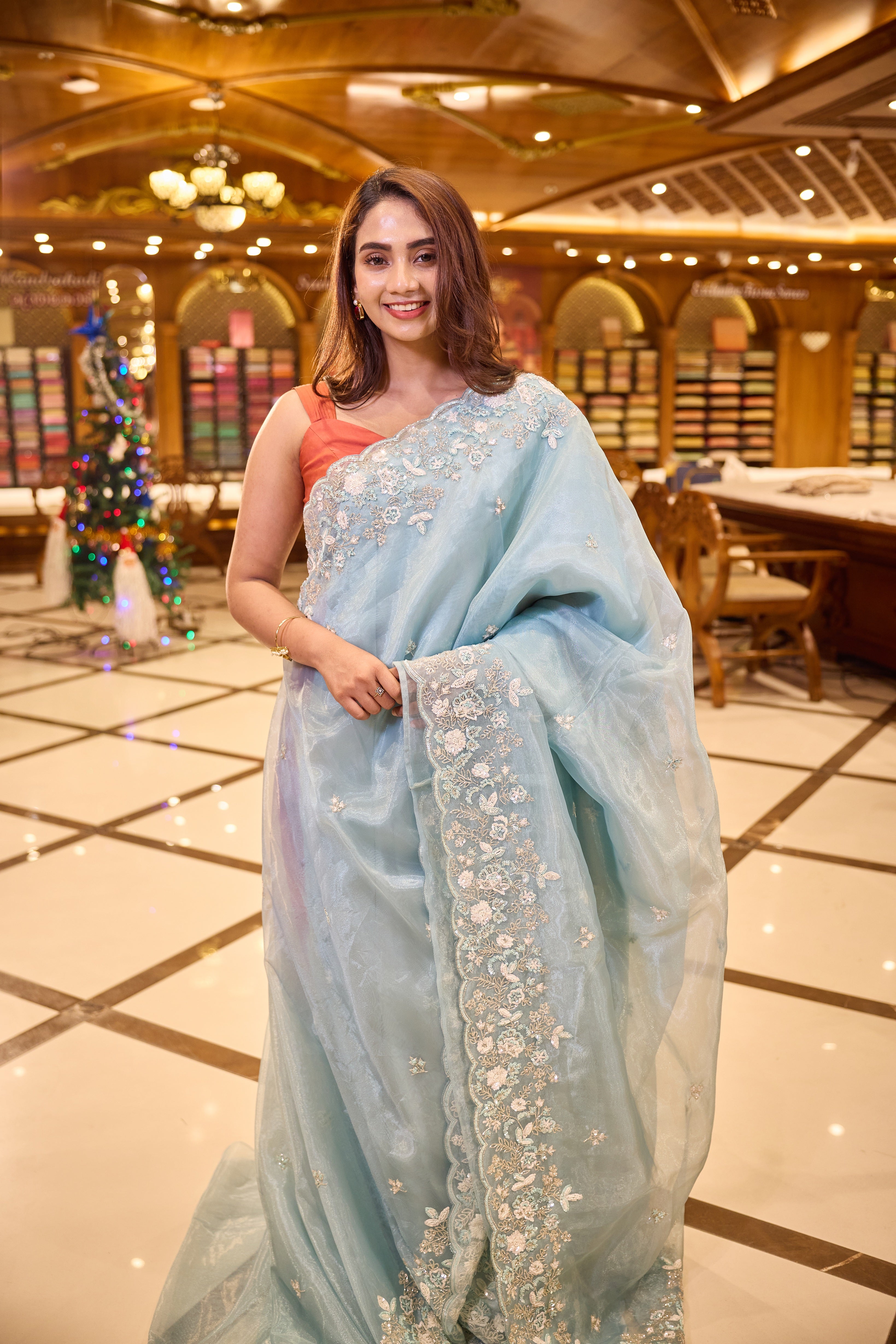 Light Blue colour Premium Designer saree crafted in fine glass organza with exquisite hand embroidered bead and sequin work, finished with an elegant scallop border, Comes with a matching worked blouse.