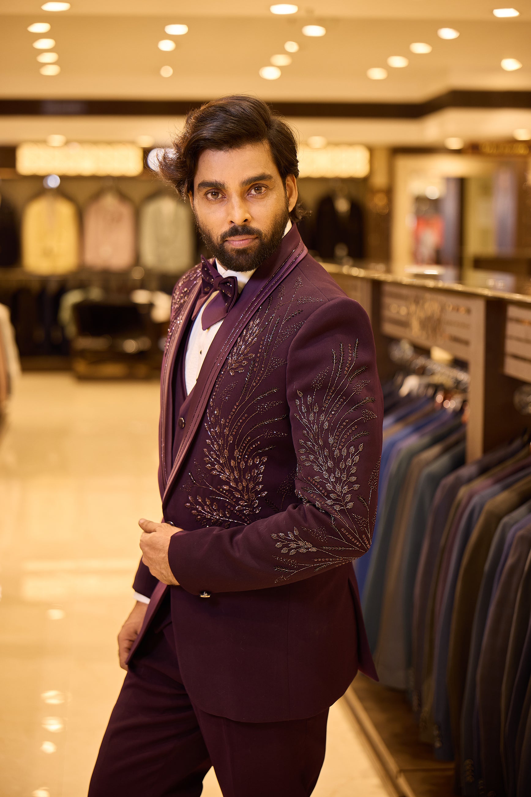 Rich purple colour 5 piece tuxedo suit crafted in premium polynosic fabric, featuring gold tone leaf beadwork all over and finished with a sleek satin lapel and single button closure for a regal groom look