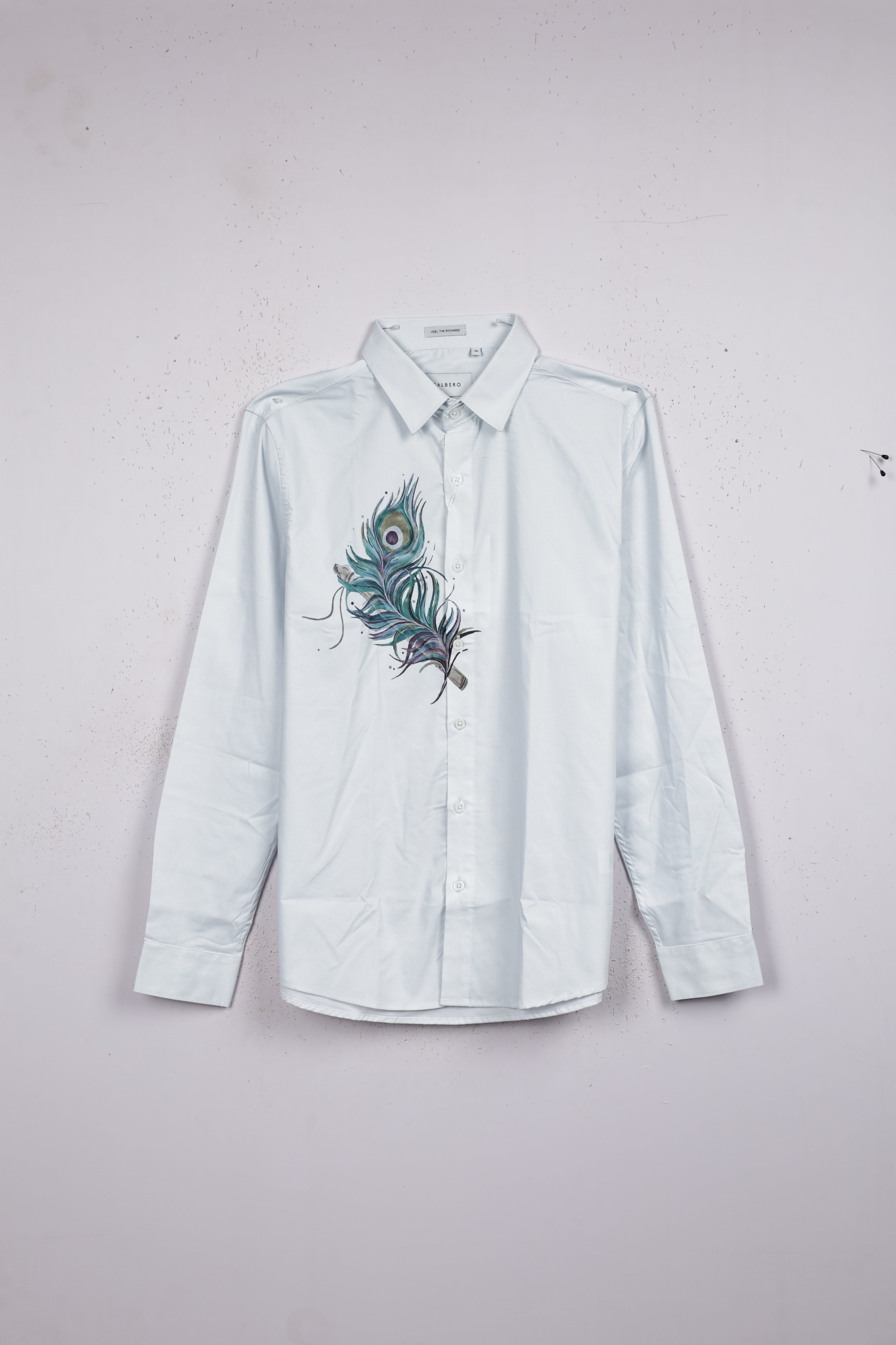 Powder Blue color shirt designed with peacock leaf print on body, full sleeve.