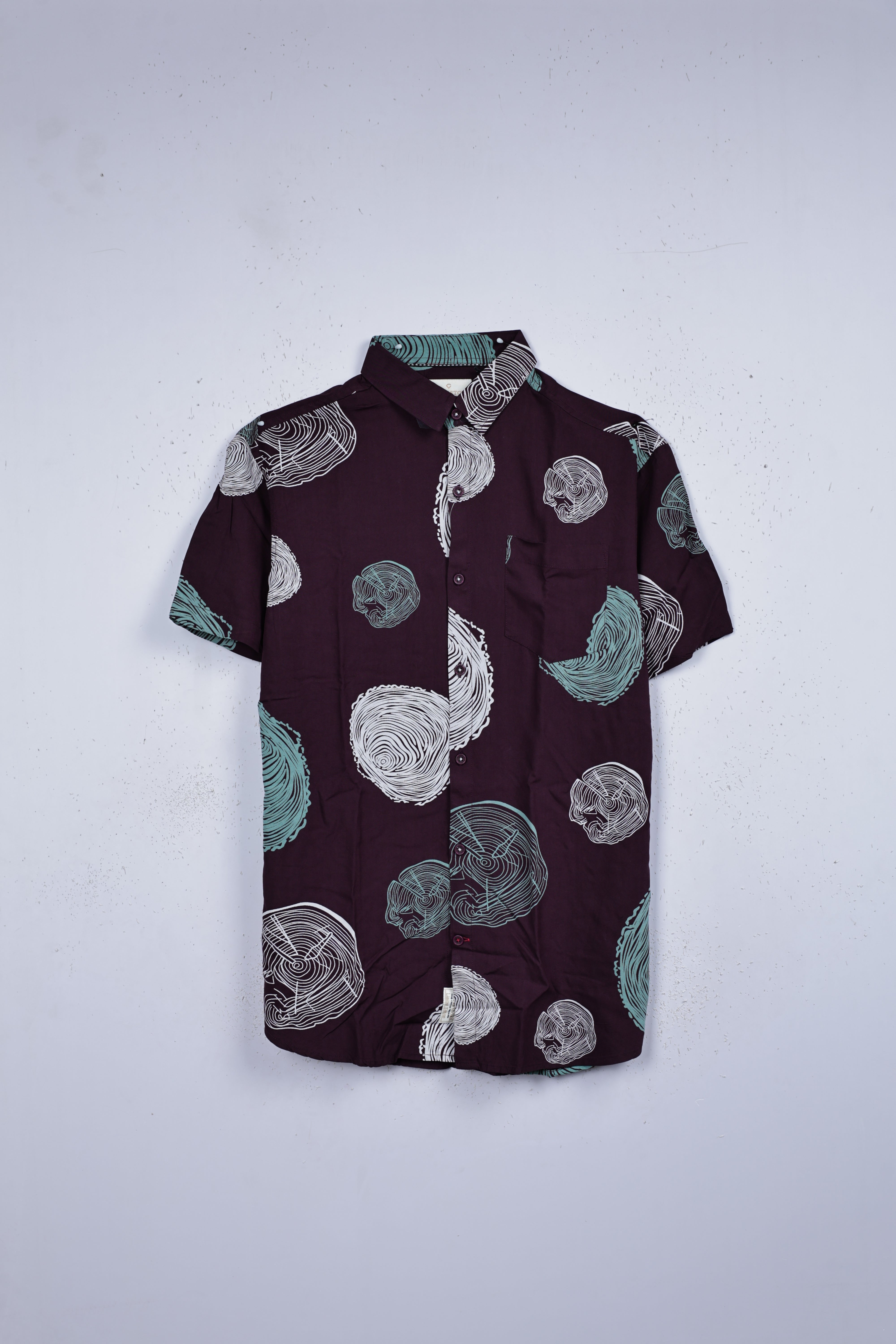 Grape colour shirt designed with white & green colour print, adored with half sleeve.