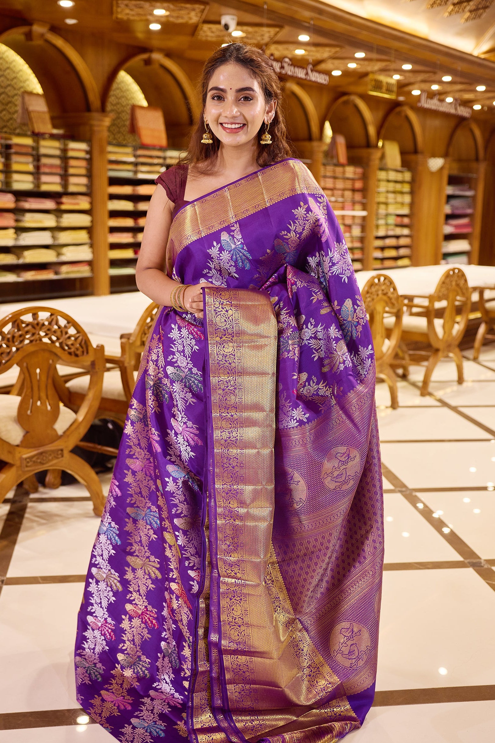 Royal purple colour Renkath Kancheepuram Samudrika Silk Saree with rich gold zari jacquard featuring intricate floral and bird motifs, complemented by a traditional zari border and paired with a matching blouse piece.