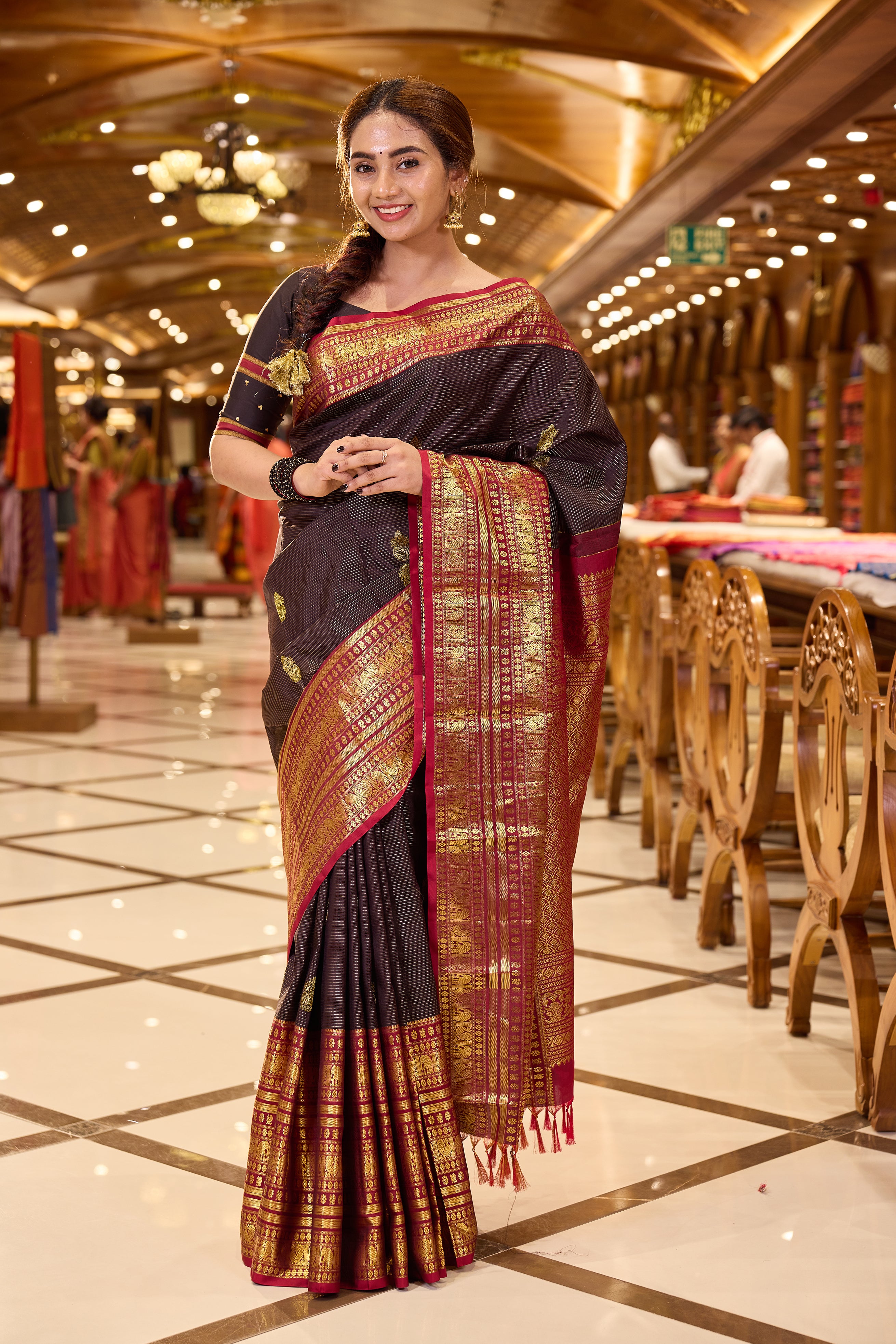 Dark Brown Kanchipuram Silk saree with traditional Vaira Oosi lines and peacock motif weaving, contrast Maroon and Gold Zari traditional long border and pallu, paired with matching blouse piece.