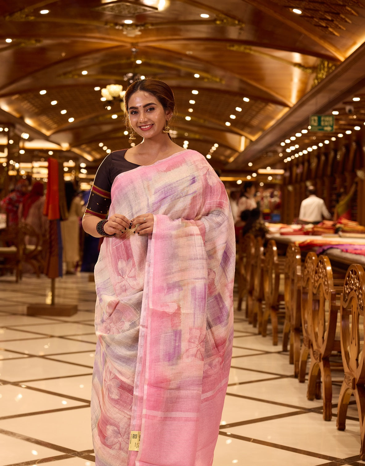 Pastel Pink Pure Linen Silk saree featuring a soft hand brushed body design in delicate hues, elegantly complemented by a shimmering silver zari border and pallu, and paired with a matching blouse piece.