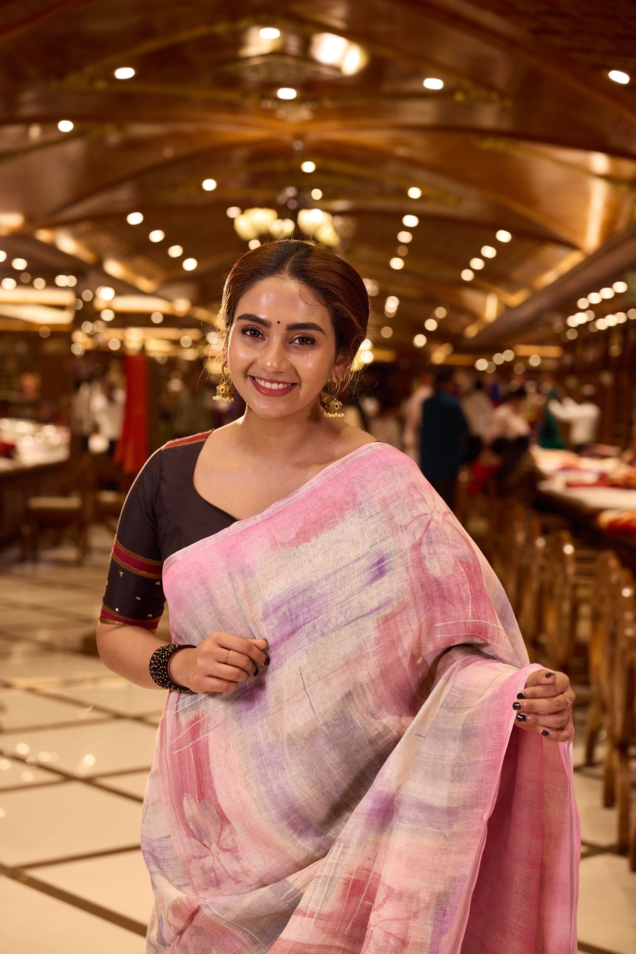 Pastel Pink Pure Linen Silk saree featuring a soft hand brushed body design in delicate hues, elegantly complemented by a shimmering silver zari border and pallu, and paired with a matching blouse piece.