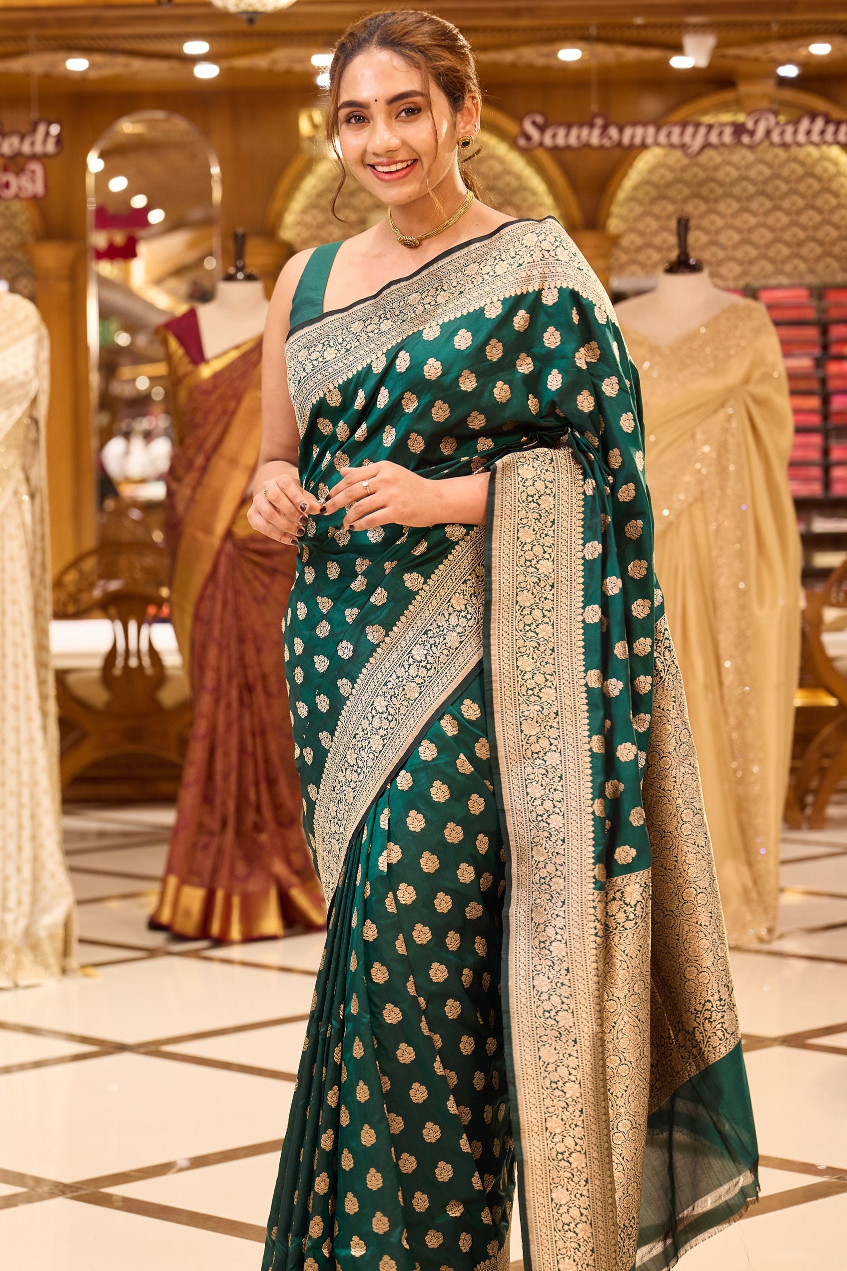 Ruby green colour pure Banaras Katan saree adorned with small motifs all over the body, featuring a traditional Banaras border and pallu, paired with a matching blouse.