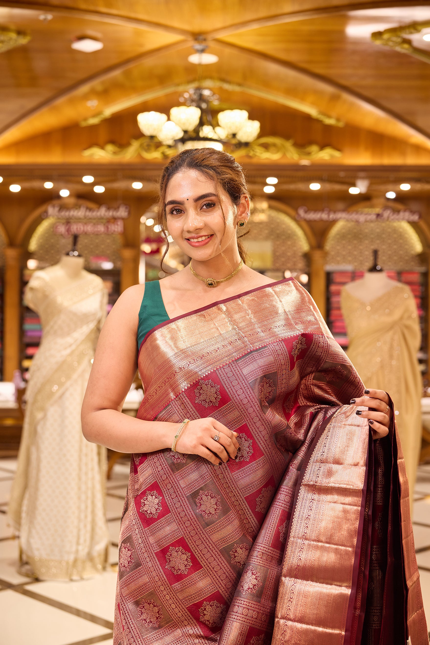 Wine Maroon Colour Kanchipuram Silk Saree with geometric box motif pattern, antique jari shimmer Meena Kari weaving, and traditional antique copper border. Paired with matching blouse piece.