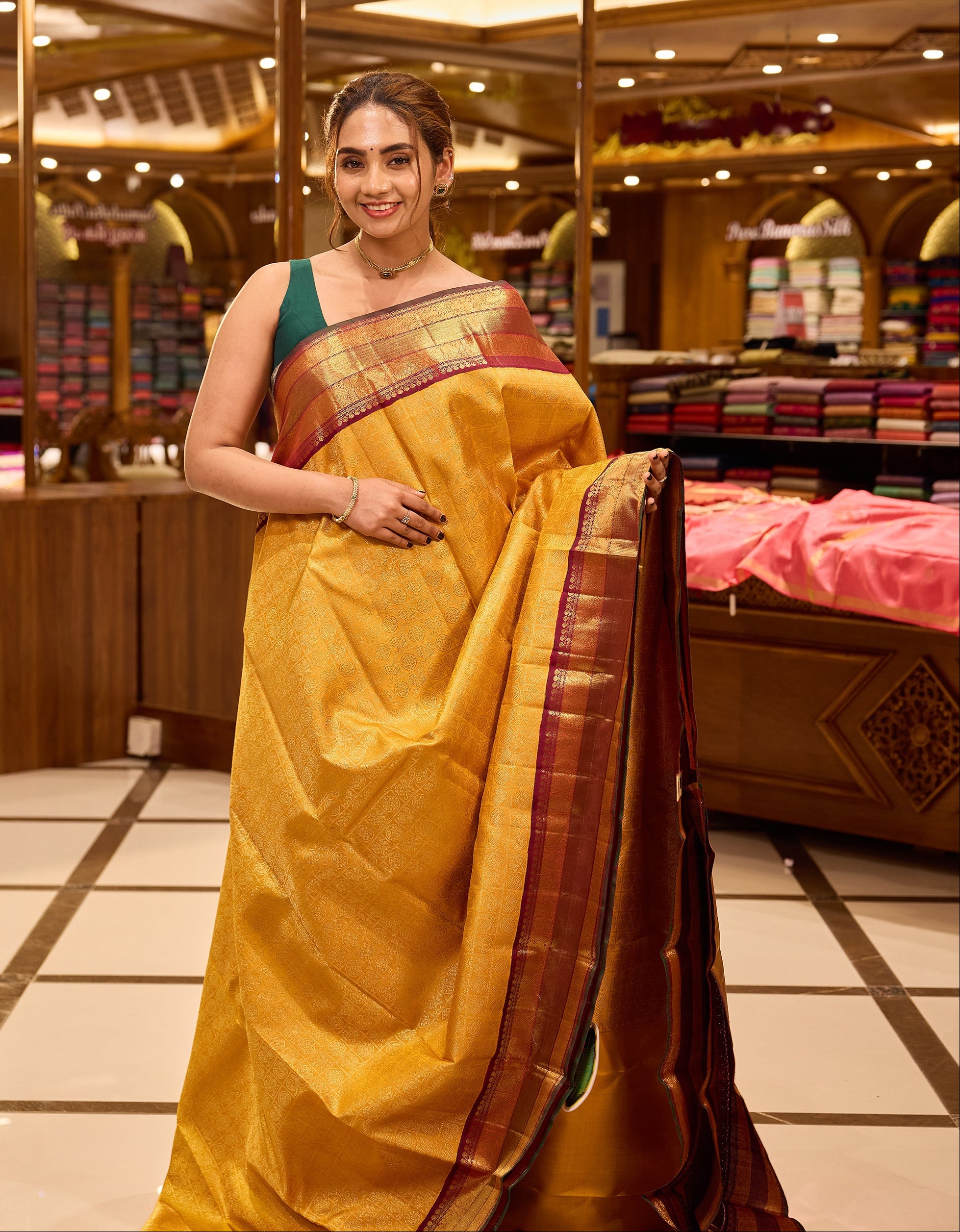 Golden mustard and wine maroon contrast Kanchipuram Samudrika Pattu saree in pure zari jacquard, featuring 3-gram gold zari peacock and chakram checks design with rich contrast border, pallu, and matching blouse.