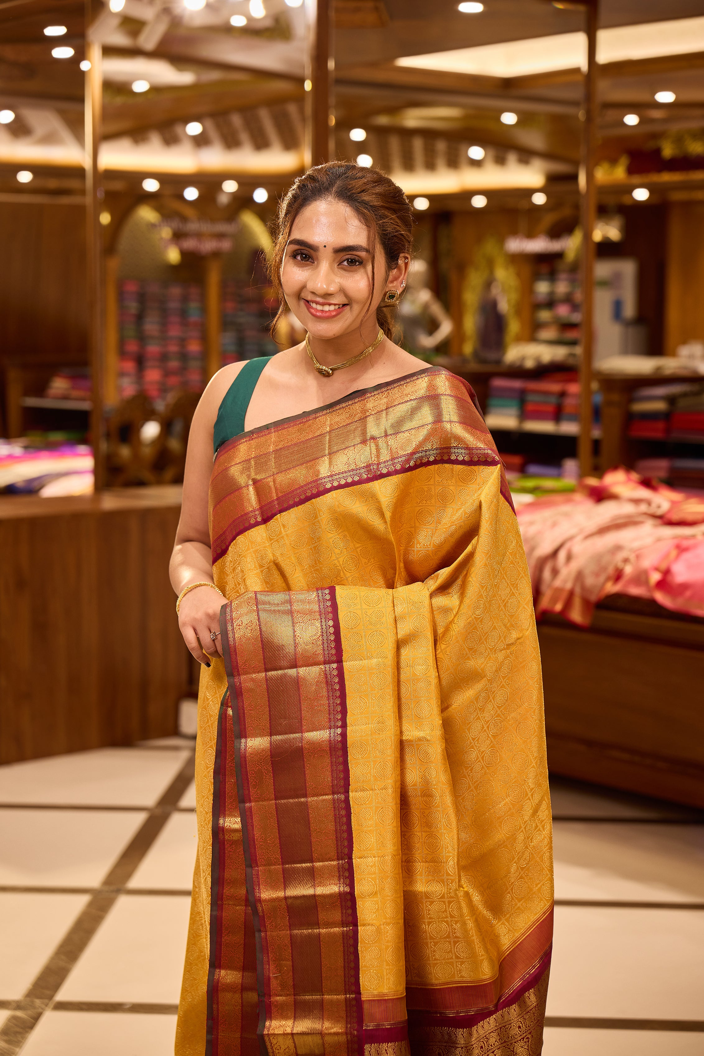 Golden mustard and wine maroon contrast Kanchipuram Samudrika Pattu saree in pure zari jacquard, featuring 3-gram gold zari peacock and chakram checks design with rich contrast border, pallu, and matching blouse.