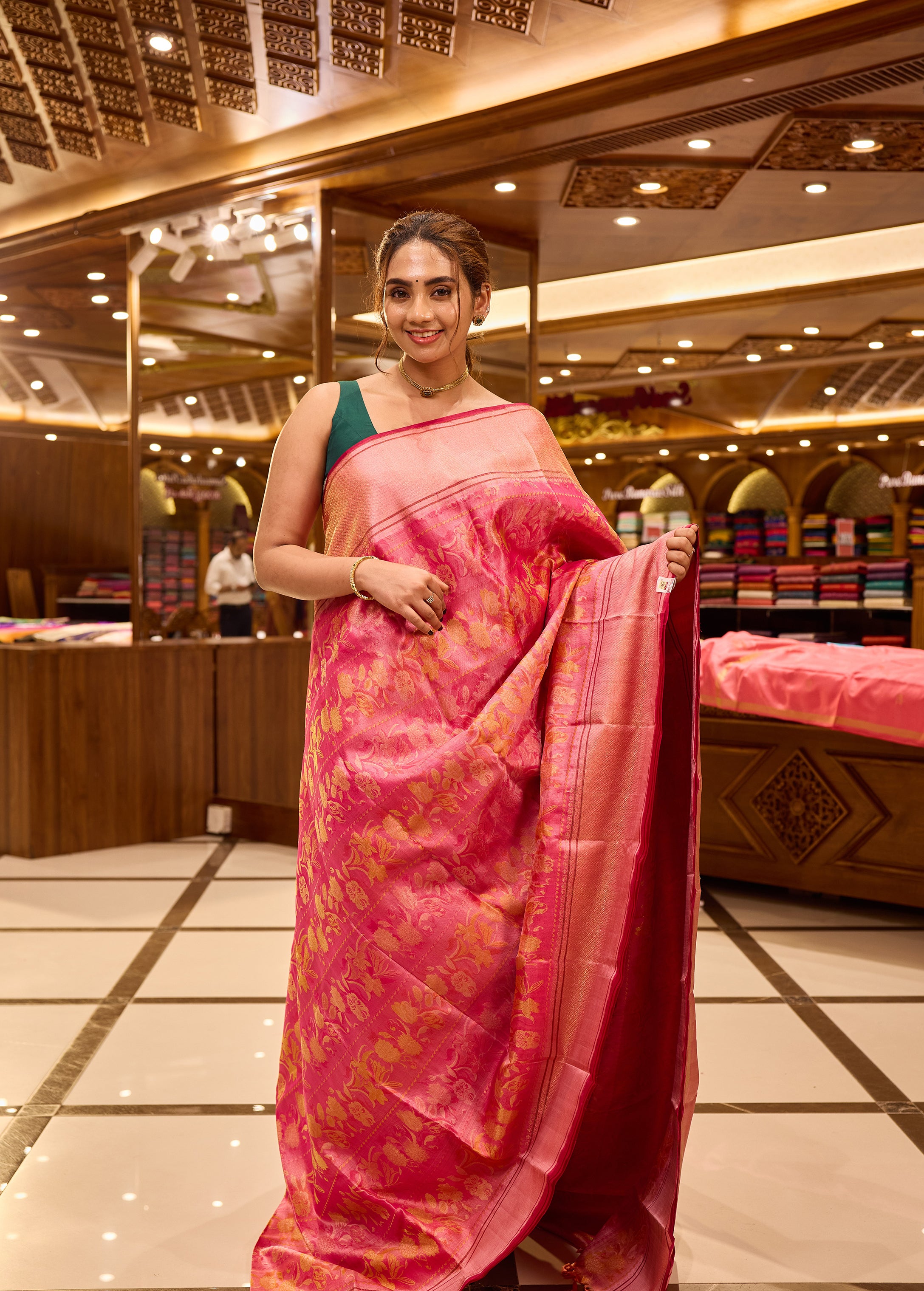 Pink colour pure Kancheepuram soft silk saree featuring floral motifs all over the body with a self colour border, complemented by a rich pallu and a matching silk blouse.