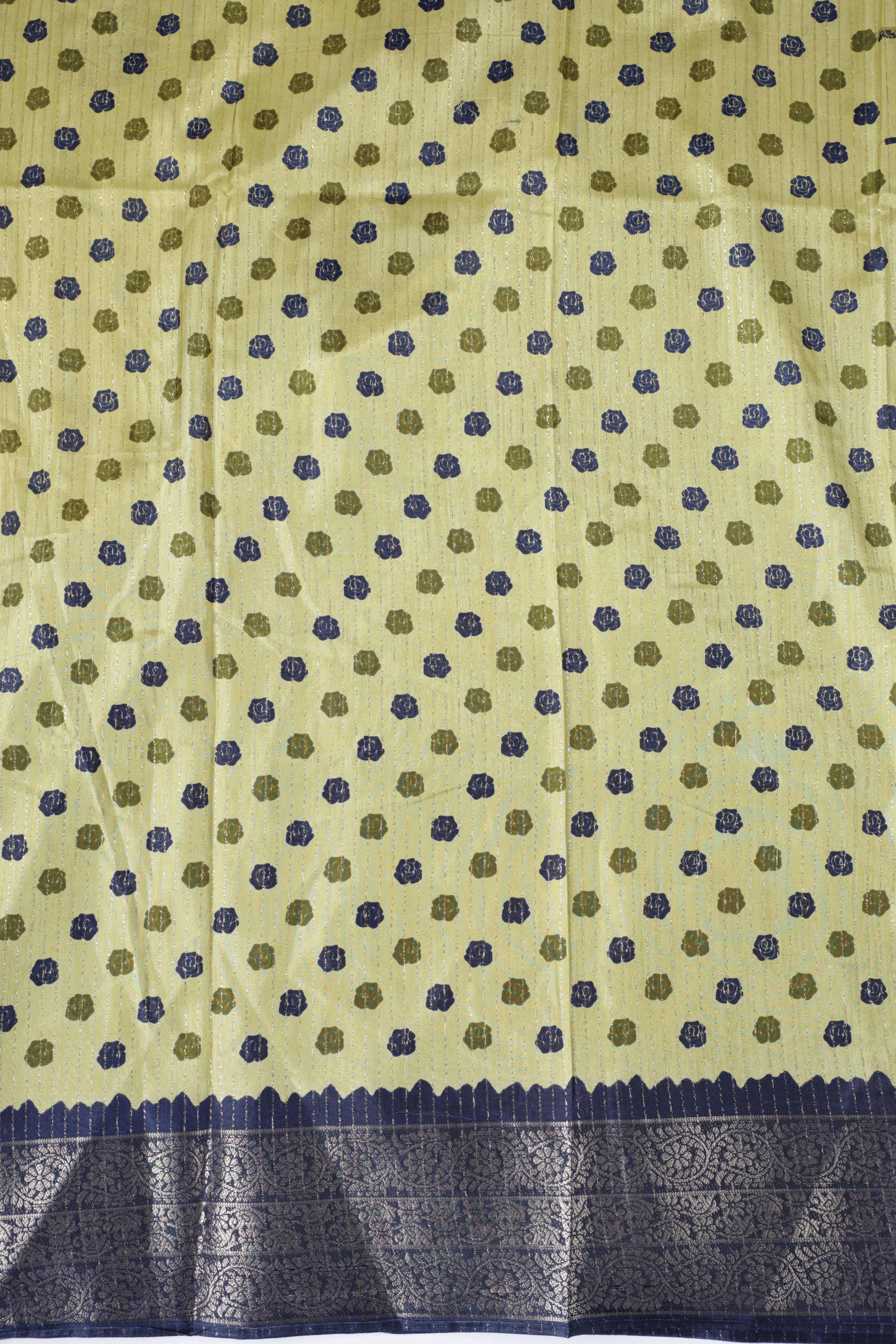 Olive green colour dolla silk saree adorned with beautiful kalamkari prints, complemented by a rich golden zari border & The pallu features intricate kalamkari detailing, paired with a matching blouse.