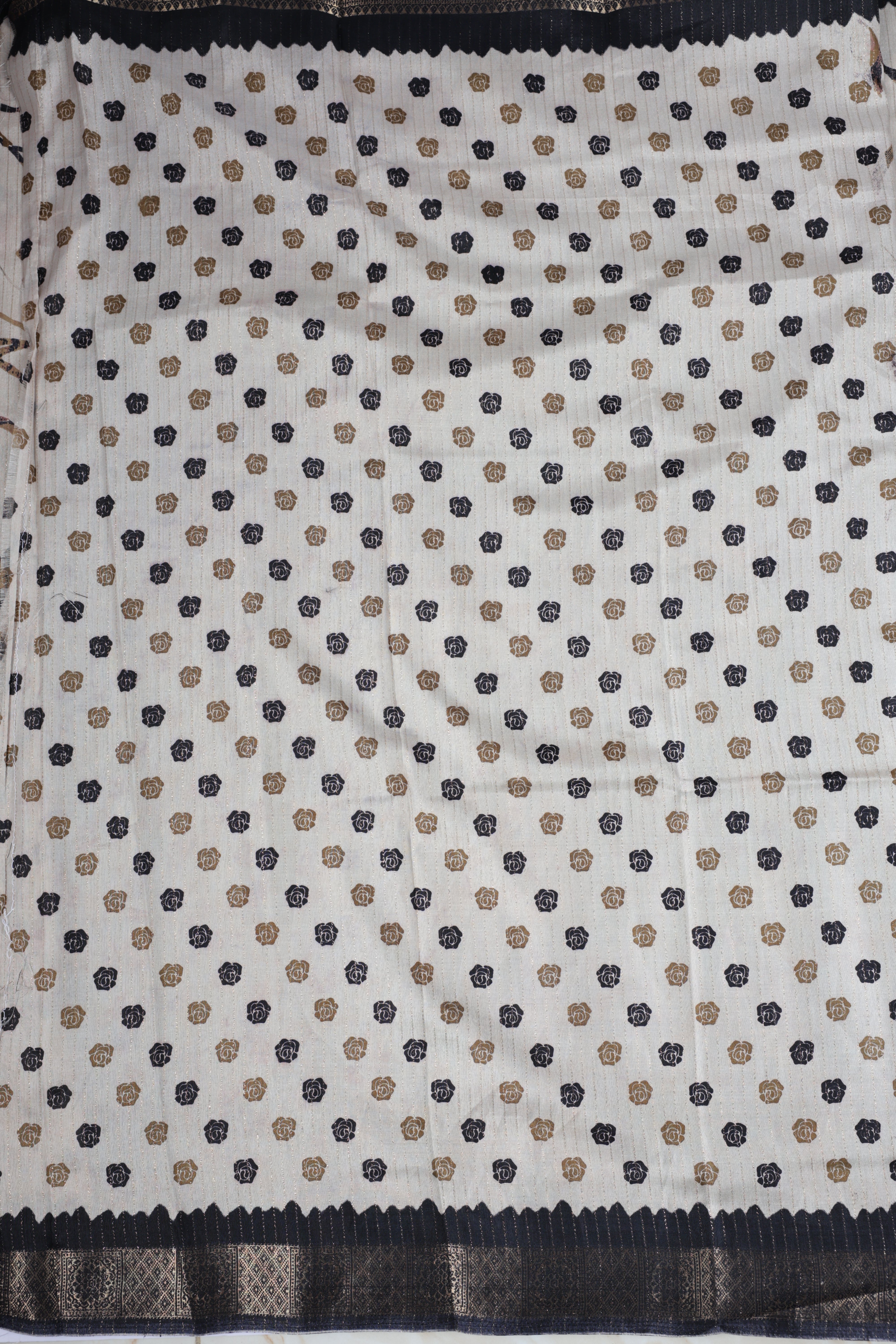 Beige colour dolla silk saree adorned with beautiful kalamkari prints, complemented by a rich golden zari border & The pallu features intricate kalamkari detailing, paired with a matching blouse.