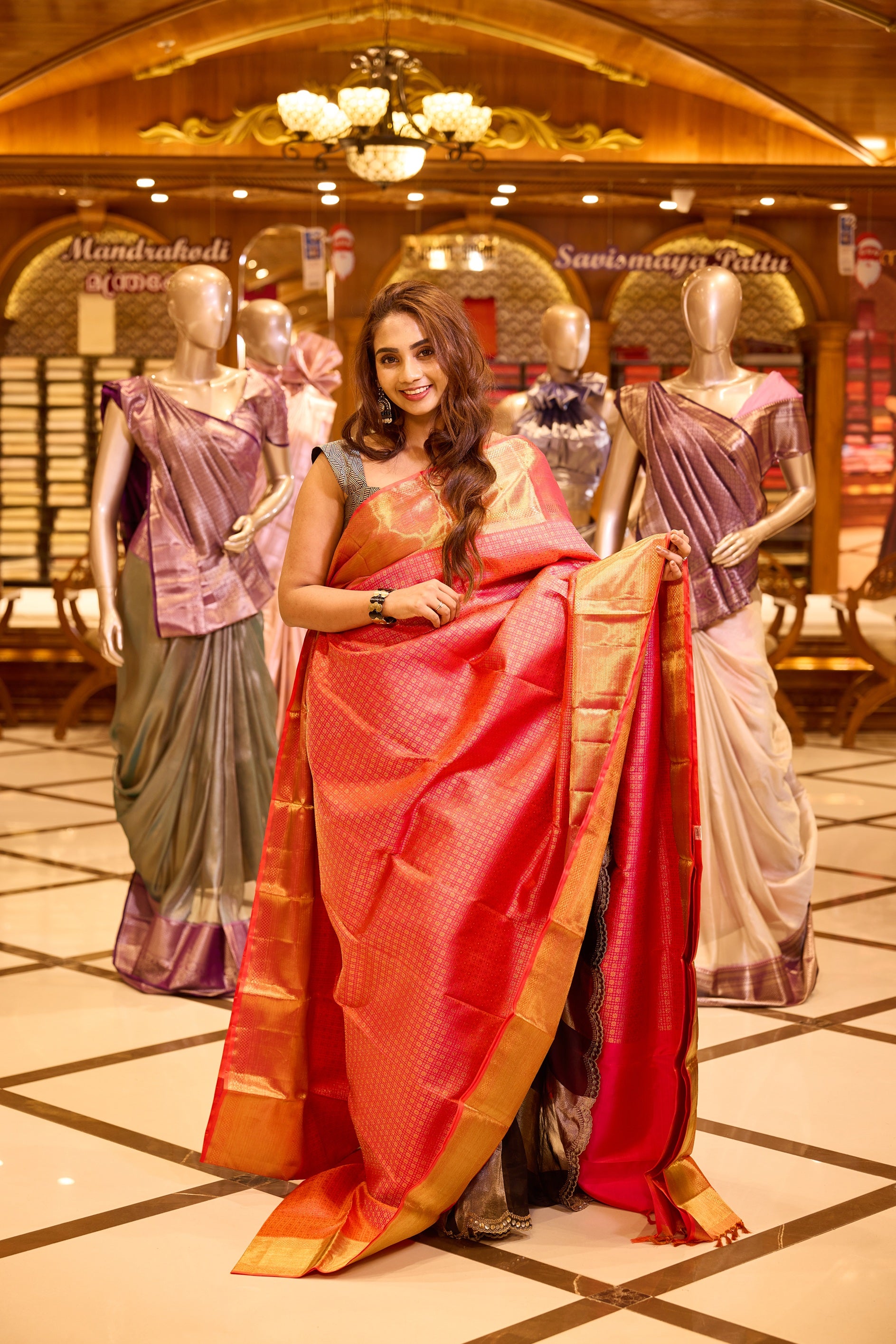 Graceful salmon pink colour Kancheepuram Samudrika Pattu Saree adorned with exclusive floral kolam concept jacquard and detailed Meenakari weaving, complemented by a classic traditional pure zari border and a matching blouse piece.