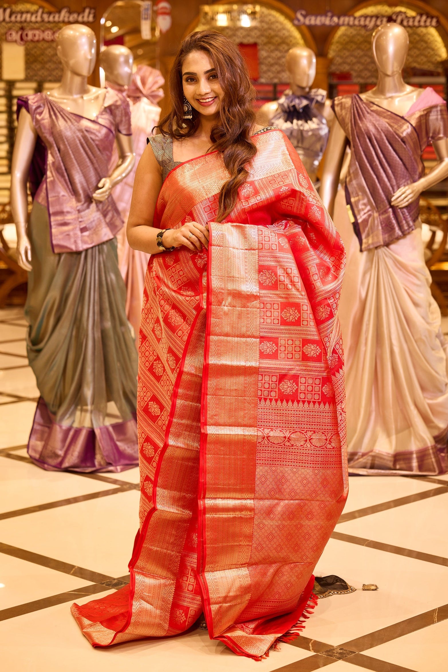 Rich chilli red colour Kancheepuram Samudrika Pattu Saree adorned with classic box pattern gold zari jacquard, highlighted by rudraksha checks and elegant floral motifs, complemented with a traditional golden zari border and a matching blouse piece.