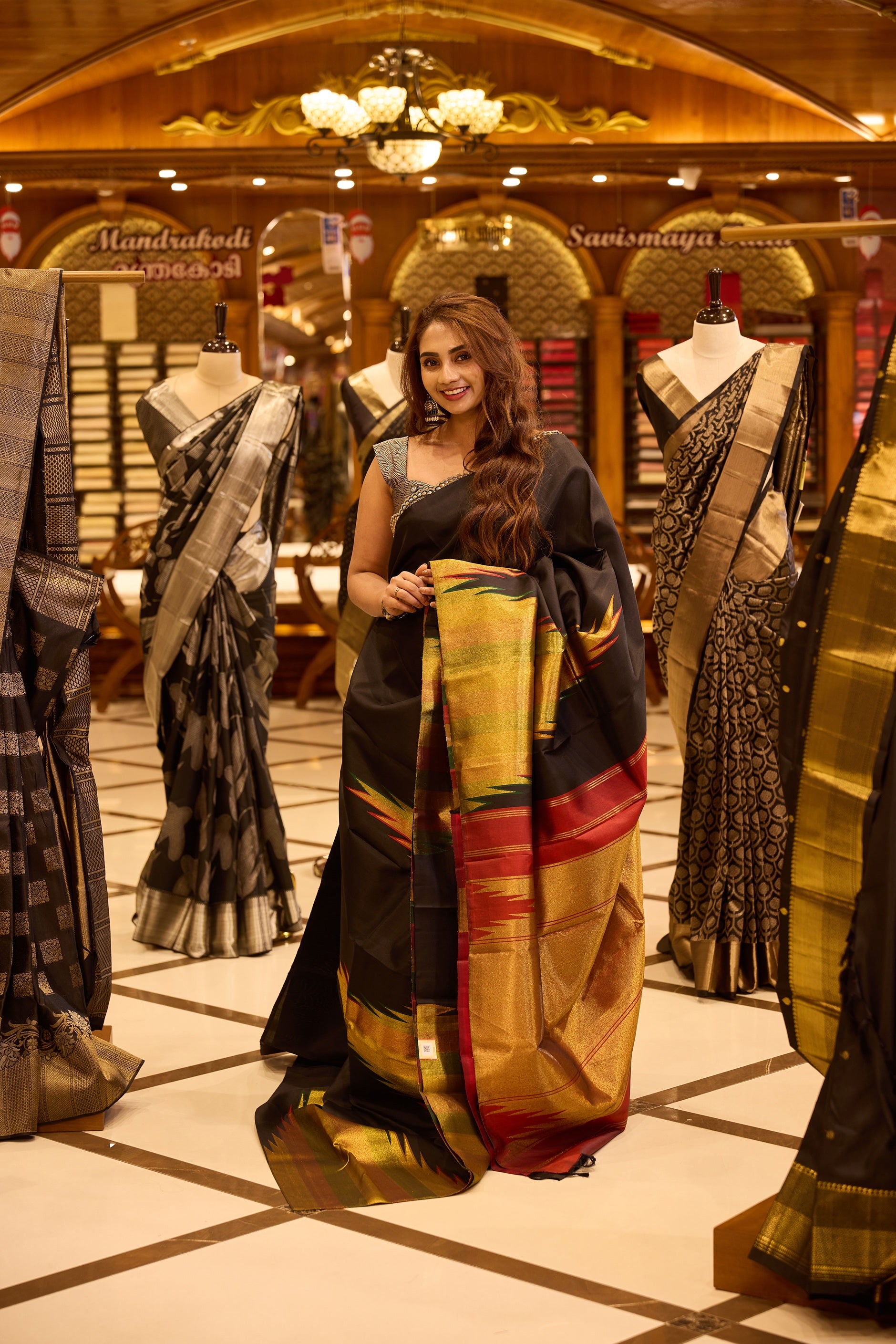 Black colour pure silk saree featuring a plain body, highlighted with a rich multicolour ikat-inspired zari pallu in gold, green and deep red hues, complemented by a tissue temple border and beautifully paired with a matching blouse.