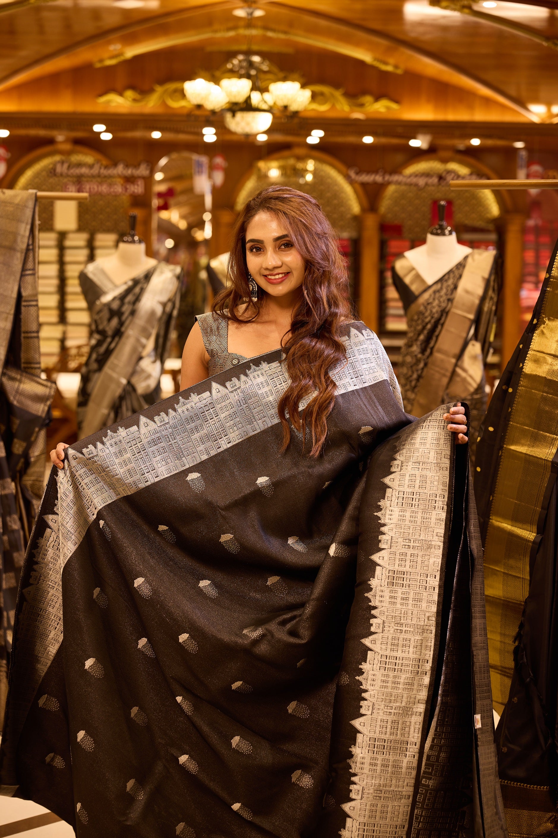 Charcoal black pure Kancheepuram silk saree with silver zari buttis, featuring a London architecture inspired silver zari pallu, a broad silver zari border, and a matching blouse