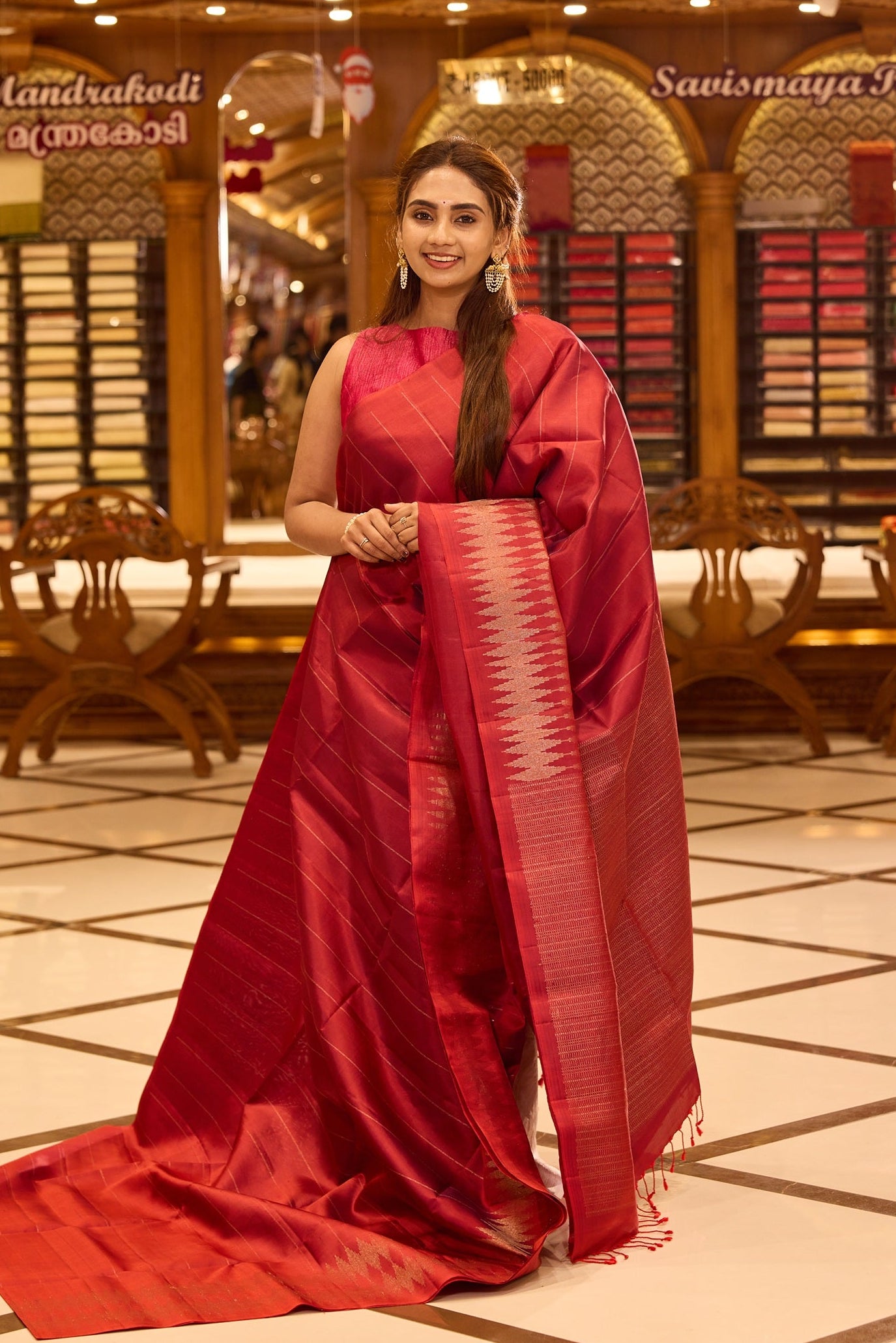 Brick red colour pure Mayuri Soft silk saree featuring a graceful striped body and a refined double temple border on one side, finished with a rich sheen and paired with a matching blouse
