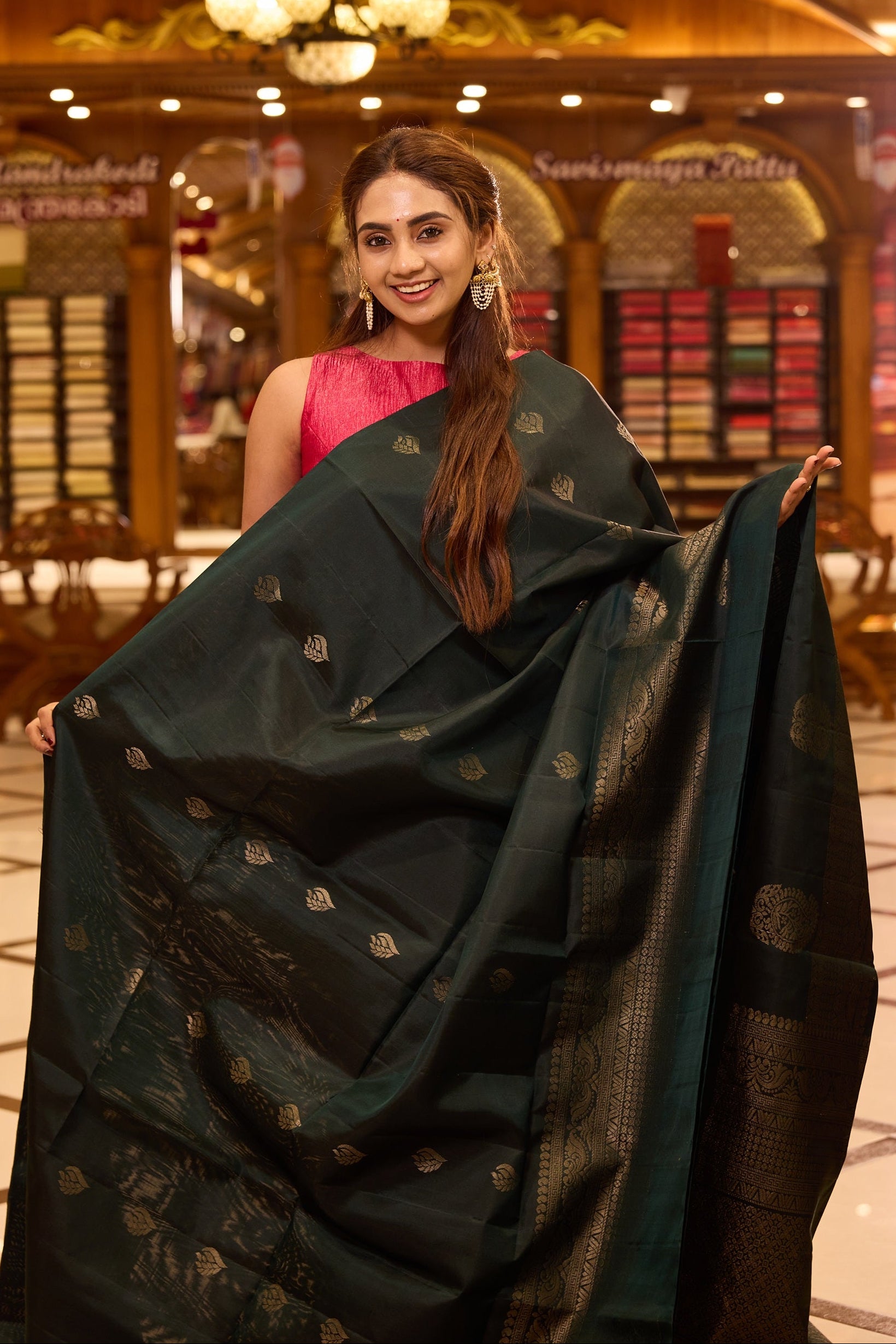Bottle green pure Mayuri Soft silk saree adorned with elegant antique zari motifs across the body, featuring a traditional antique zari pallu and a refined one side border, gracefully paired with a matching blouse