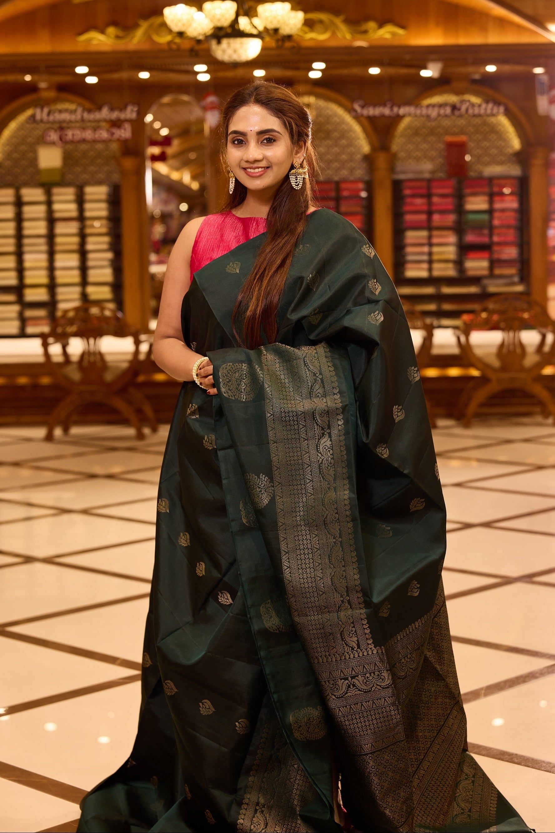 Bottle green pure Mayuri Soft silk saree adorned with elegant antique zari motifs across the body, featuring a traditional antique zari pallu and a refined one side border, gracefully paired with a matching blouse