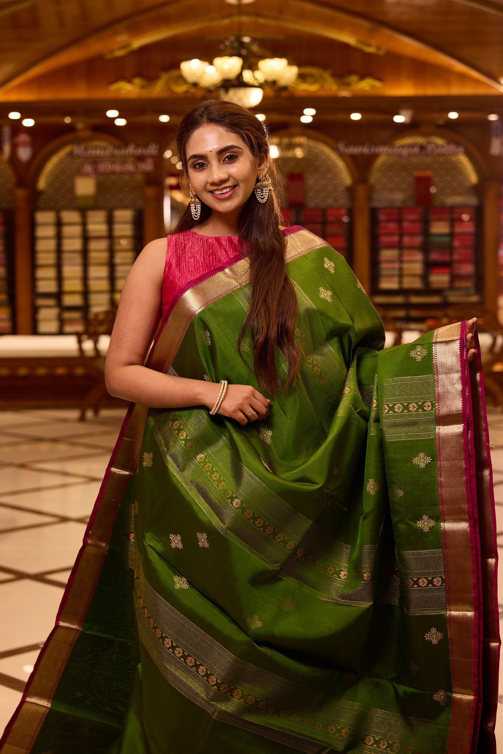 Vibrant parrot green colour Kancheepuram silk saree adorned with delicate gold zari motifs across the body, beautifully complemented by a classic zari border with hints of contrast, styled with a blouse