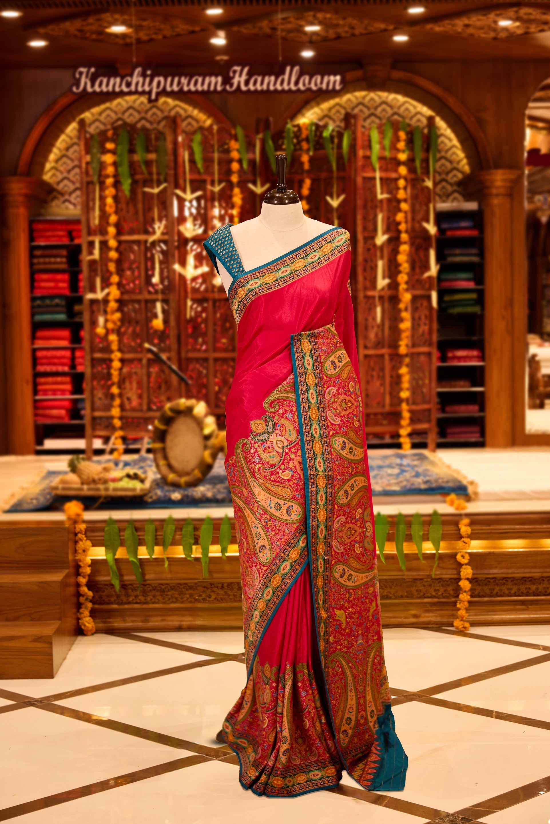 Magenta colour Pashmina silk saree beautifully woven with intricate paisley and floral motifs in vibrant multicolour weaves, framed by teal and gold ornamental borders and an elaborate artistic pallu, paired with a coordinated woven blouse piece.