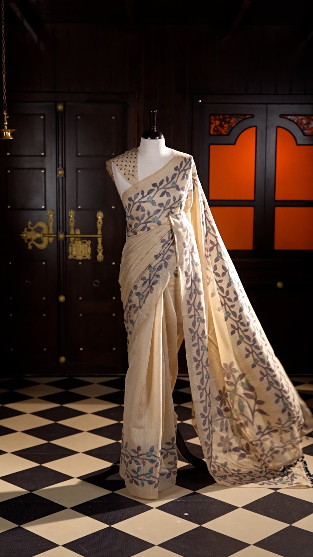 Beige colour Semi Jute Material saree with leaf print and floral design on body, finished with a floral designed matching blouse.