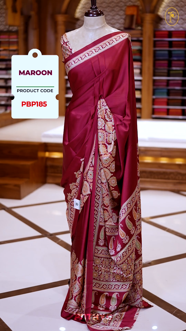 Maroon Semi modal silk saree featuring traditional Ajrakh print with intricate motifs and contrast borders, paired with a perfectly matching blouse & A timeless piece blending heritage with grace.