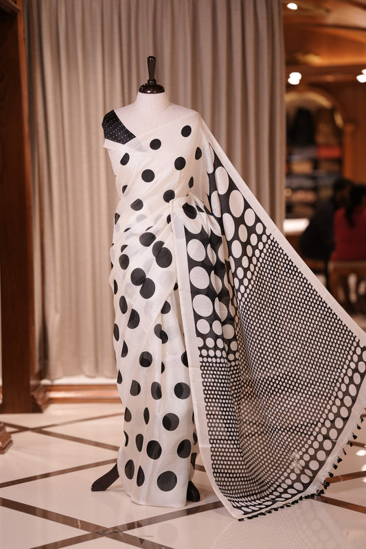 Black colour Semi khadi cotton saree featuring charming polka dot designs on the body, The contrast pallu with off white small dots adds a stylish highlight & Comes with a matching blouse piece adorned with contrast small motifs.