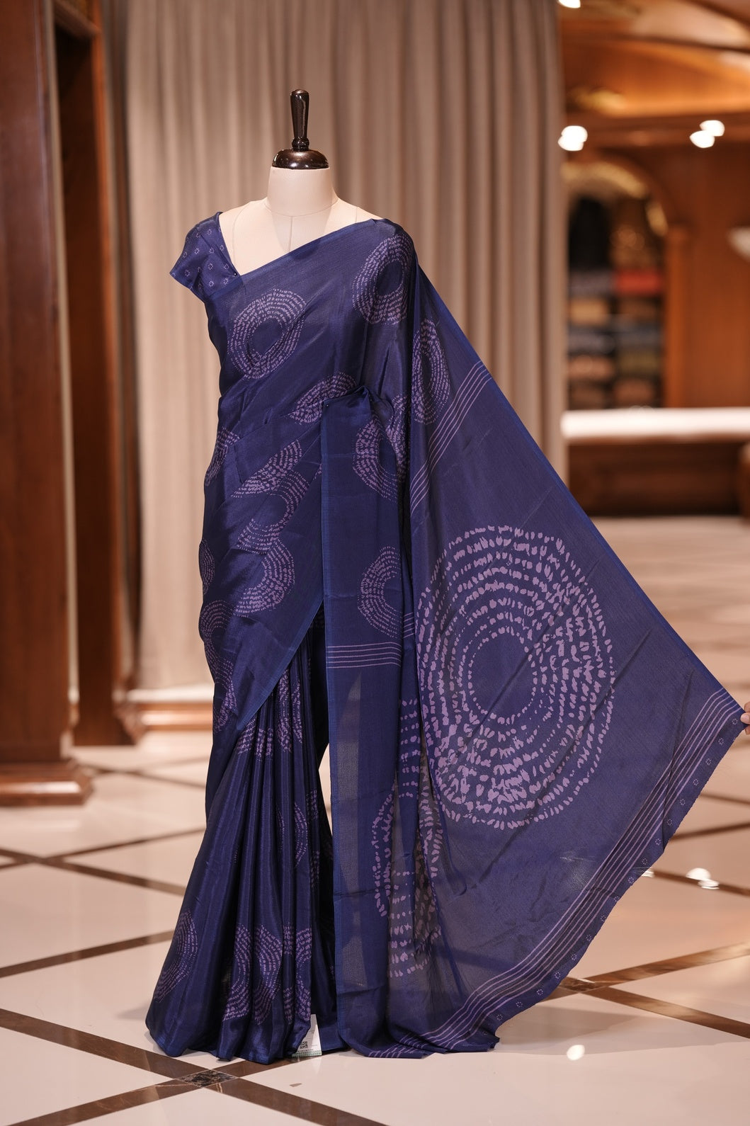 Navy Blue colour Turkey crepe saree featuring elegant circle designs all over, with a large circular pattern on the pallu and delicate small circle motifs on the matching blouse piece for a graceful look.