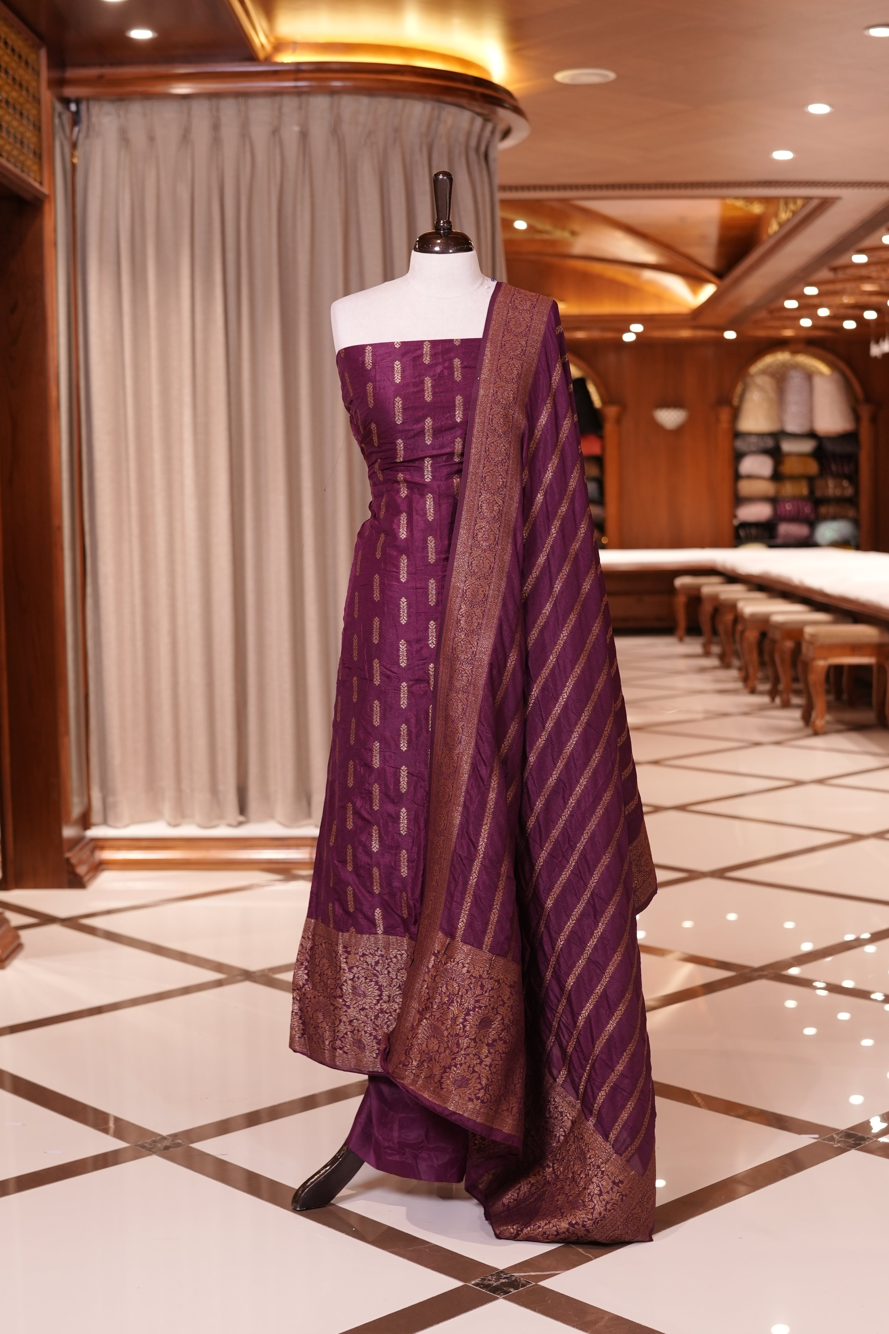 Wine colour Semi Banarasi Silk top adorned with elegant Copper zari patterns and a rich border, paired with a zari worked dupatta and a plain bottom.