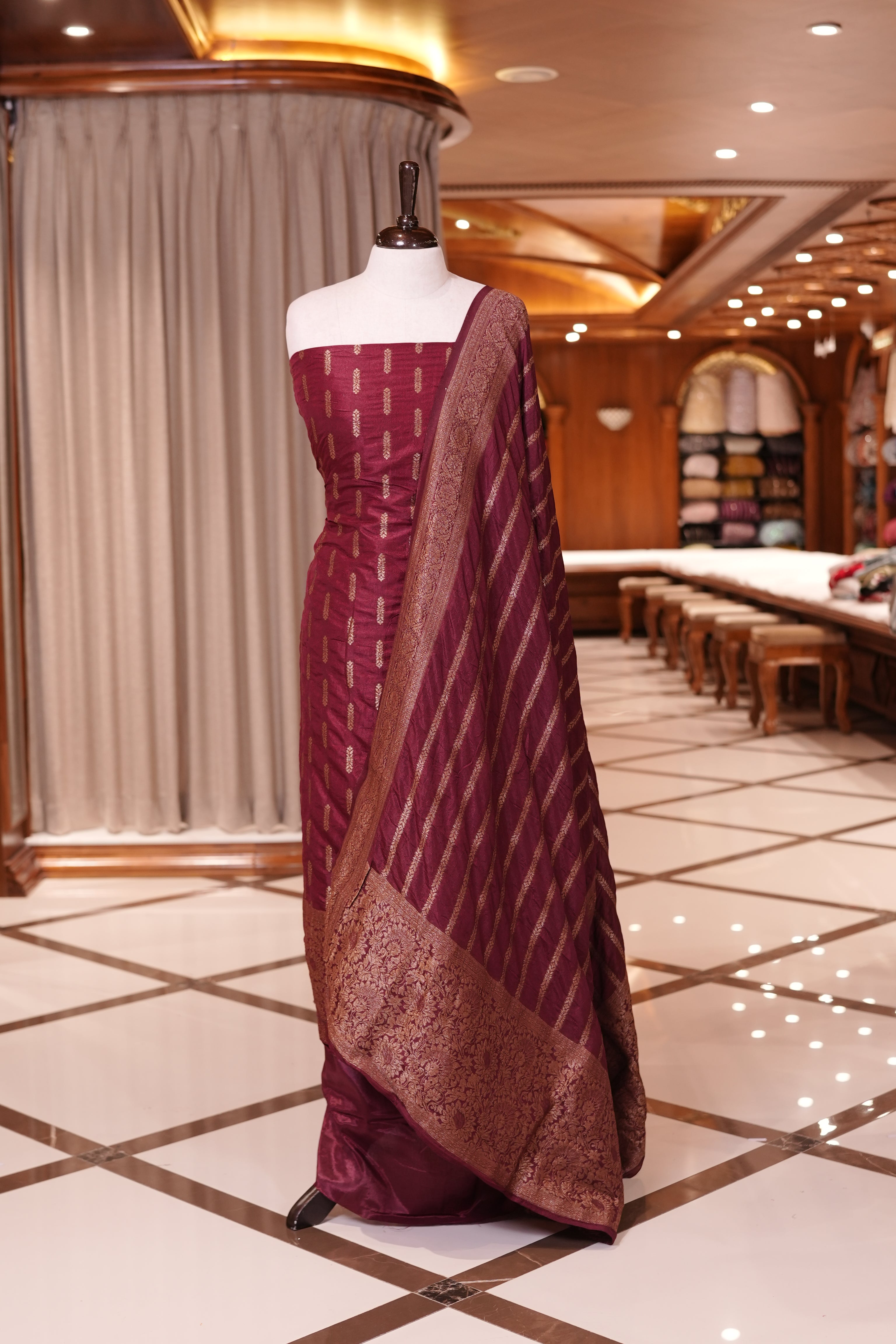 Maroon colour Semi Banarasi Silk top adorned with elegant Copper zari patterns and a rich border, paired with a zari worked dupatta and a plain bottom.