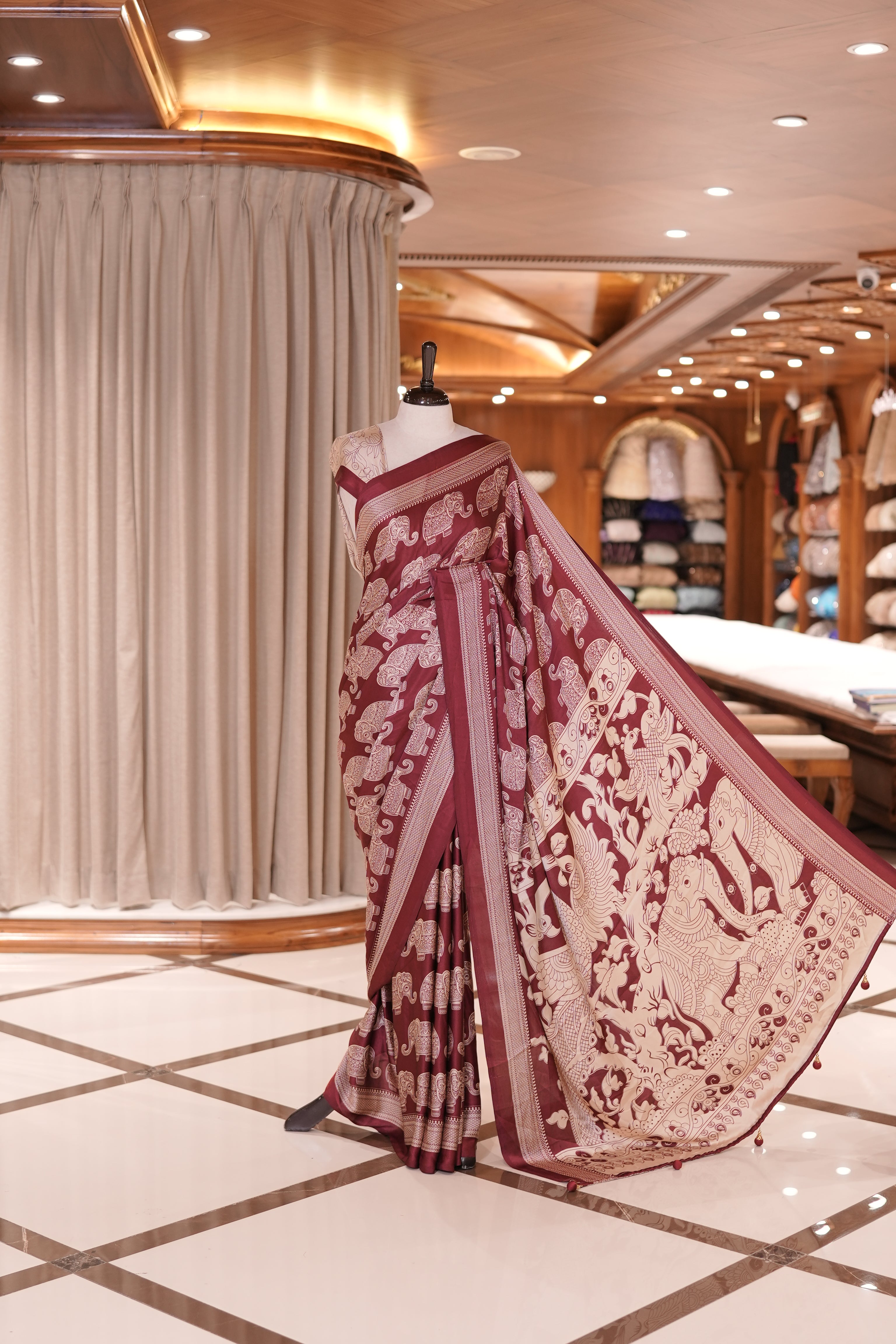 Maroon & Cream satin modal saree featuring intricate elephant motifs and an artistic pallu, paired with a matching blouse
