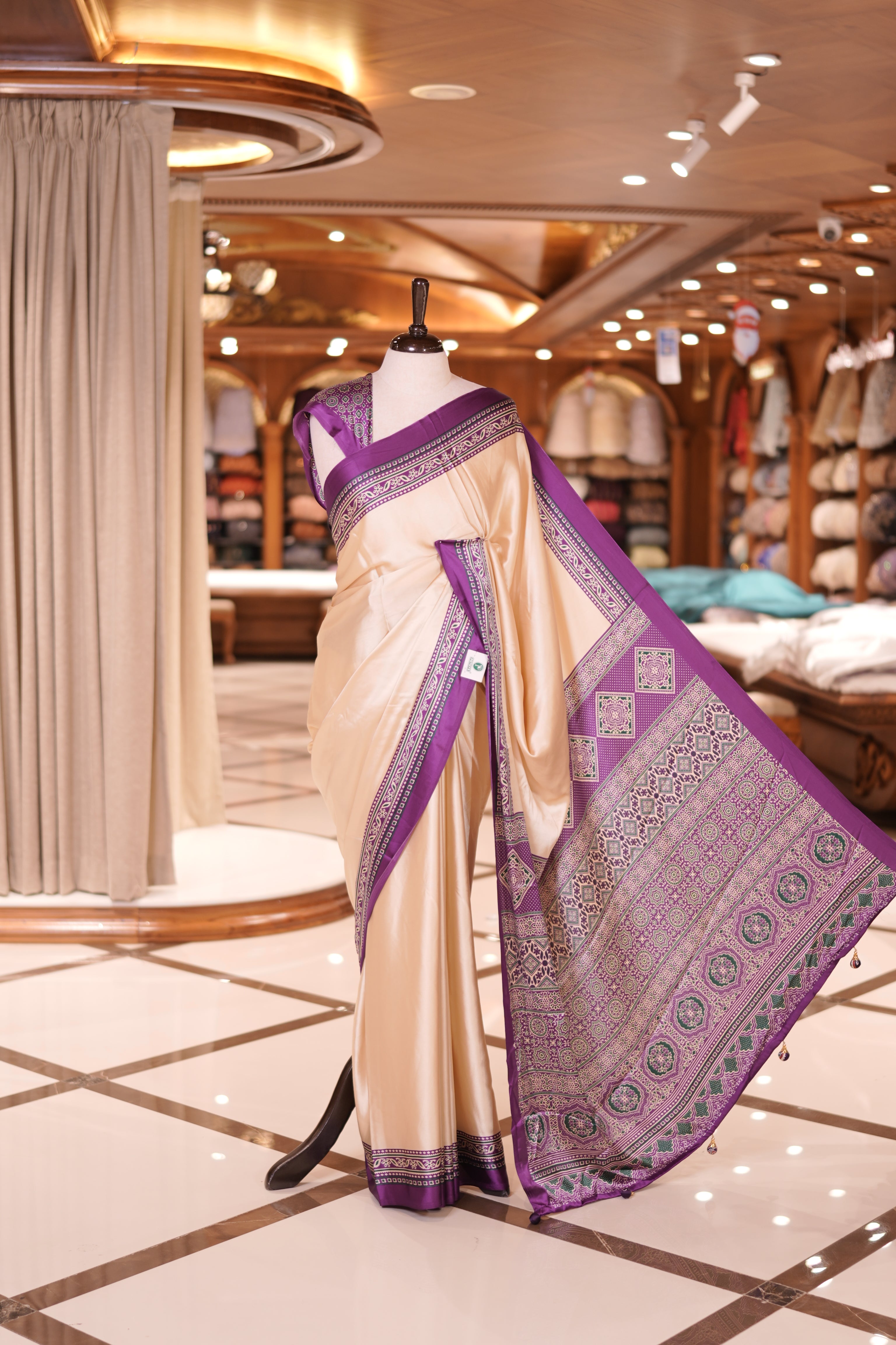 Cream colour semi modal saree featuring an elegant Purple border with intricate woven designs and a richly detailed pallu, paired with a matching blouse