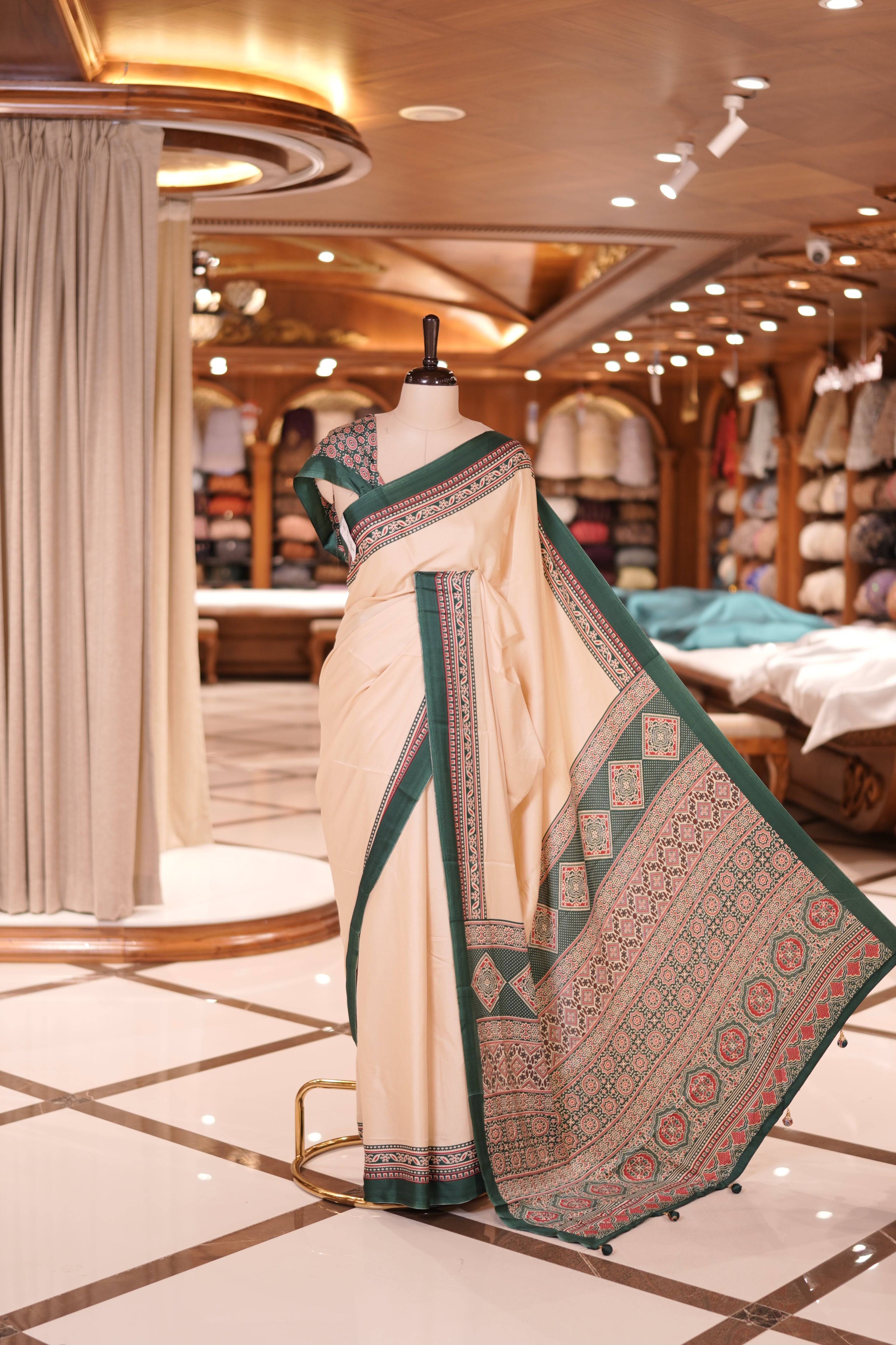 Cream colour semi modal saree featuring an elegant Green colour border with intricate woven designs and a richly detailed pallu, paired with a matching blouse