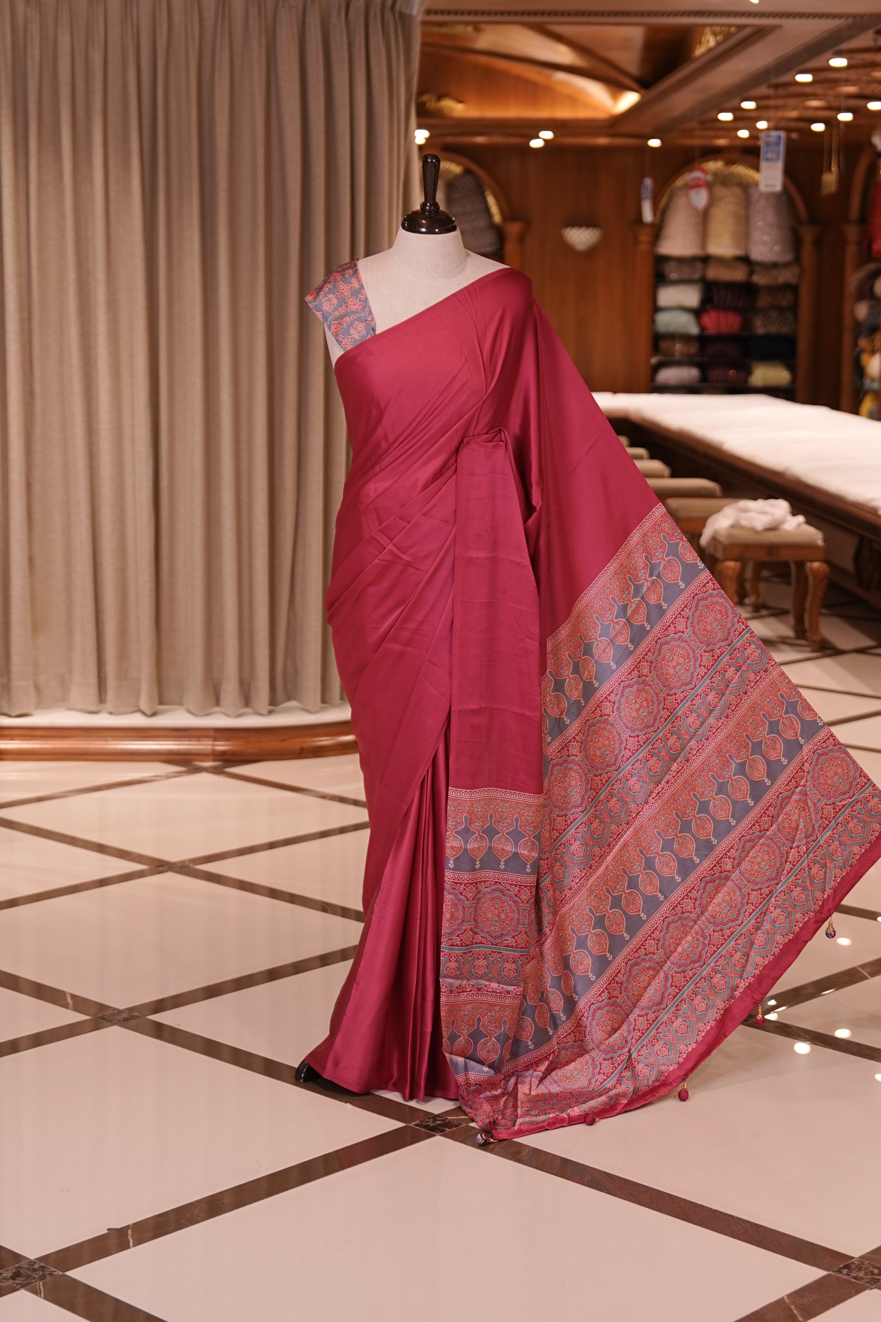 Pink Colour semi modal saree featuring a graceful solid body, beautifully enhanced with an intricately woven contrast Ajrakh printed pallu and a perfectly matching Ajrakh blouse.