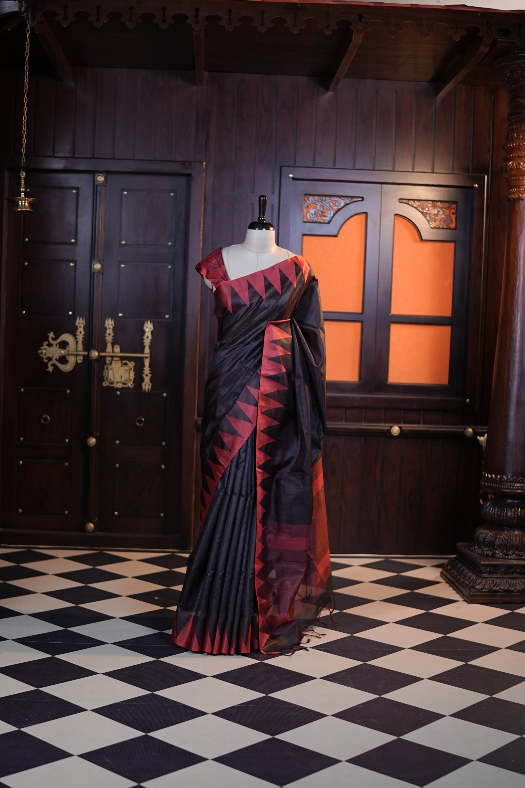 Black colour Net cotta saree featuring a striped body with a contrast colored traditional temple-design border, a striped pallu, and paired with a matching blouse.