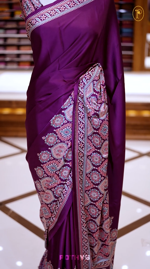 Purple Semi modal silk saree featuring traditional Ajrakh print with intricate motifs and contrast borders, paired with a perfectly matching blouse & A timeless piece blending heritage with grace.
