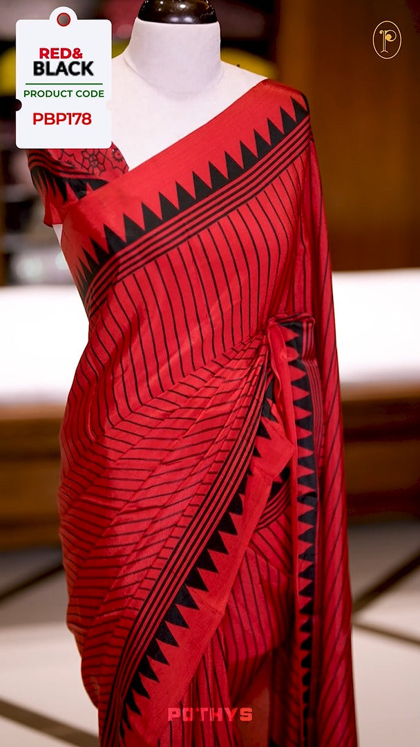 Red semi modal crepe saree featuring black vertical line prints, complemented by a temple border and circle butta design on the pallu, paired with a matching printed blouse.