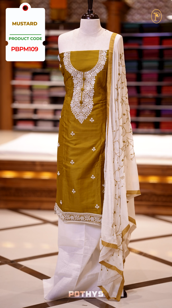 Mustard colour semi silk salwar set highlighted with intricate white chikankari embroidery on the neckline and body, paired with matching bottom and contrasting ivory dupatta.