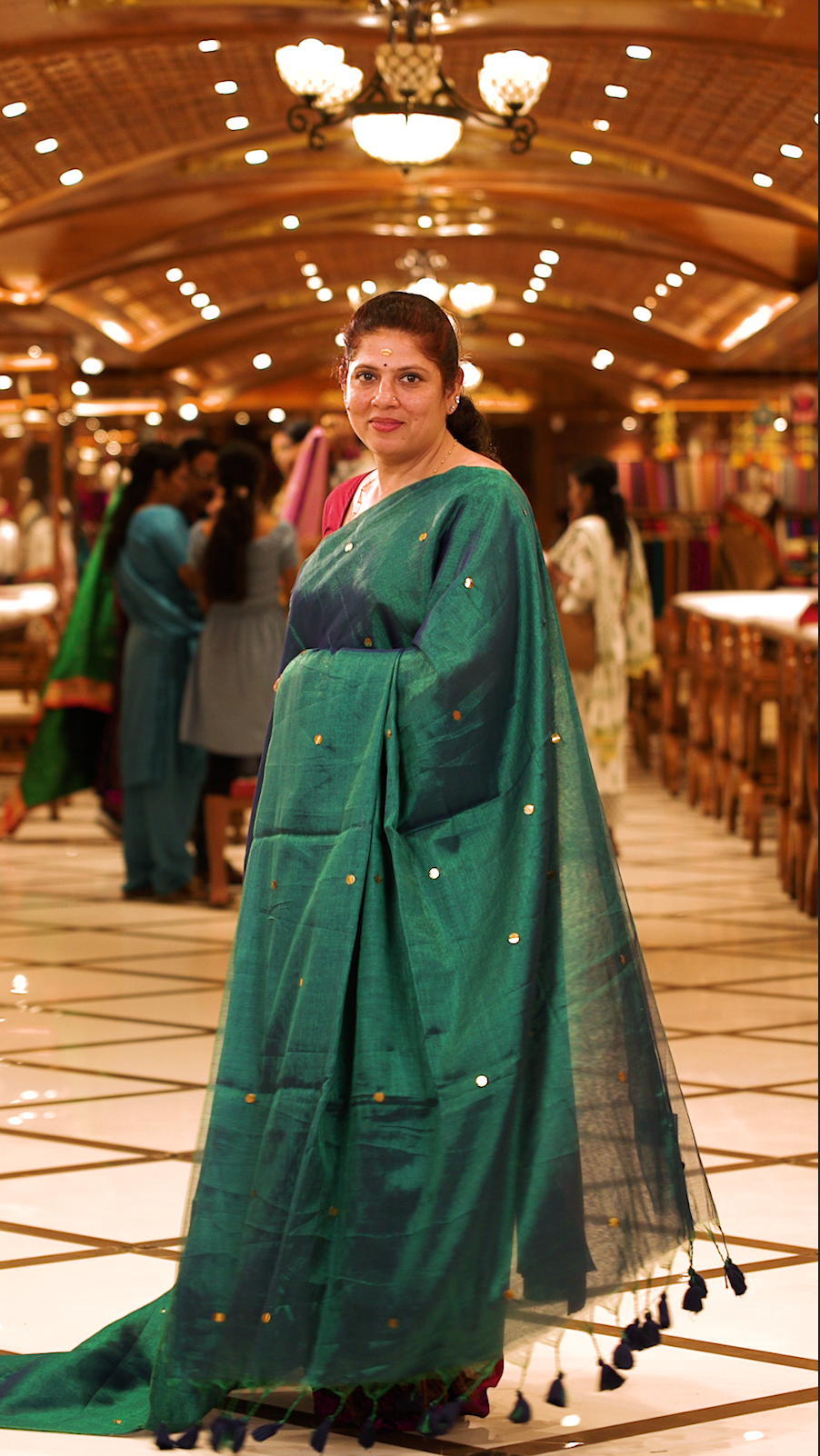Peacock green colour Semi Tissue saree featuring a plain body adorned with delicate sequin detailing throughout, crafted in a borderless design. Comes without a blouse piece.