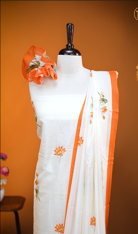 Cream colour Vijithra Silk Material Featuring Orange Lotus Print On body, comes with same colour Dupatta Enhance Beautiful Floral print with small Orange border