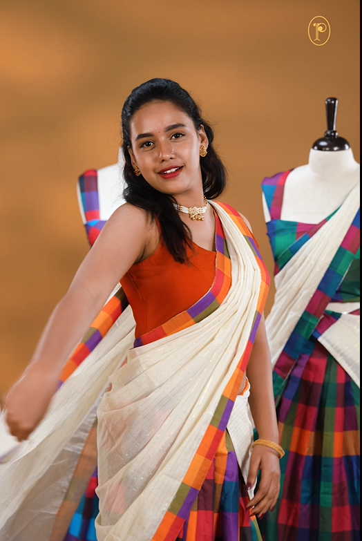 Orange, Purple, Red & Olive colour Dhavani set featuring Check pattern skirt, comes with Matching blouse piece, Paired with white Dupatta With gold zari strip & Madras check border.