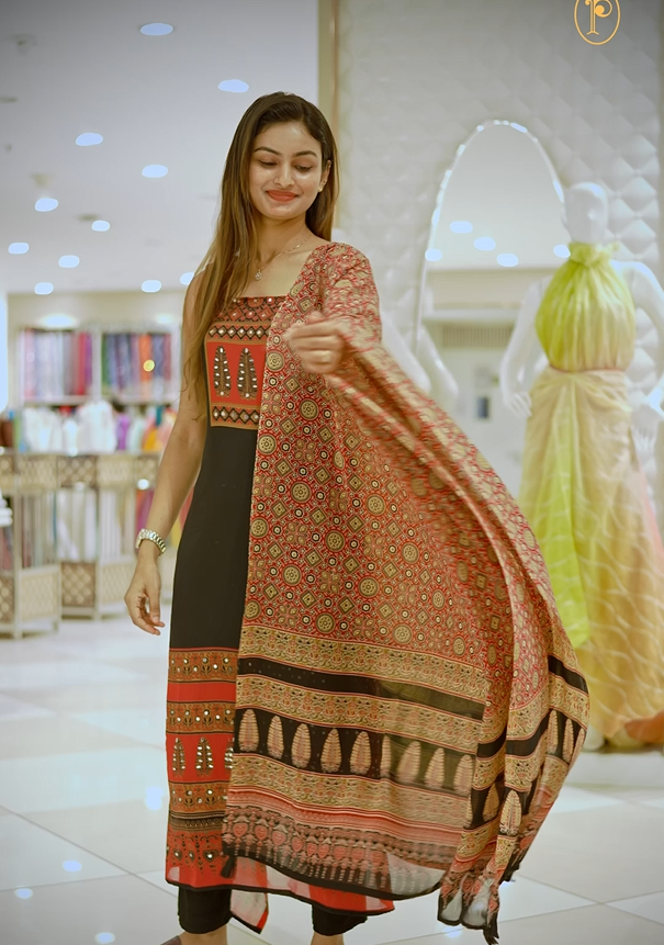 Black colour georgette salwar material featuring Daman Print Detailing Mirror work on neck portion, a dupatta with Same print , and Shantoon bottom.