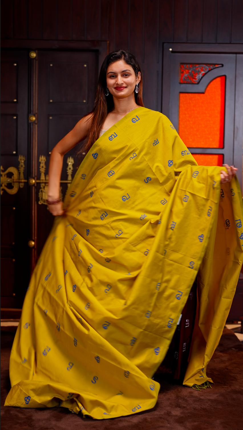 Olive Yellow colour Poly cotton saree featuring Malayalam Letters Print on body, pallu with tassels, Contrast Colour Blouse piece.