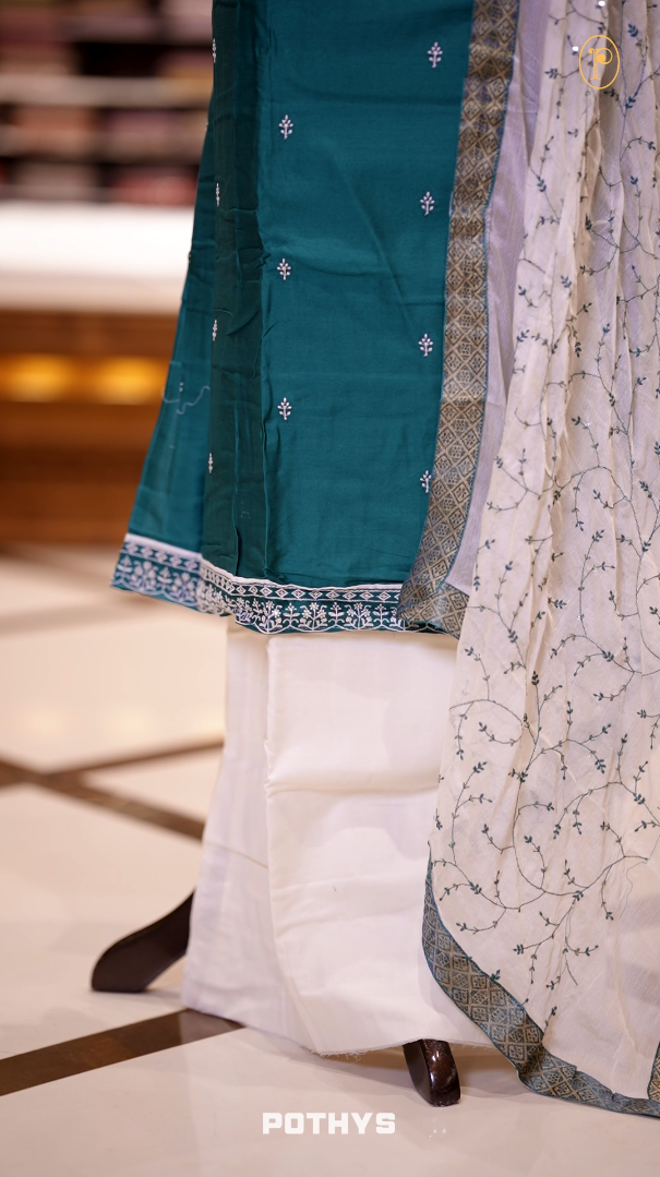 Blue colour semi silk salwar set highlighted with intricate white chikankari embroidery on the neckline and body, paired with matching bottom and contrasting ivory dupatta.